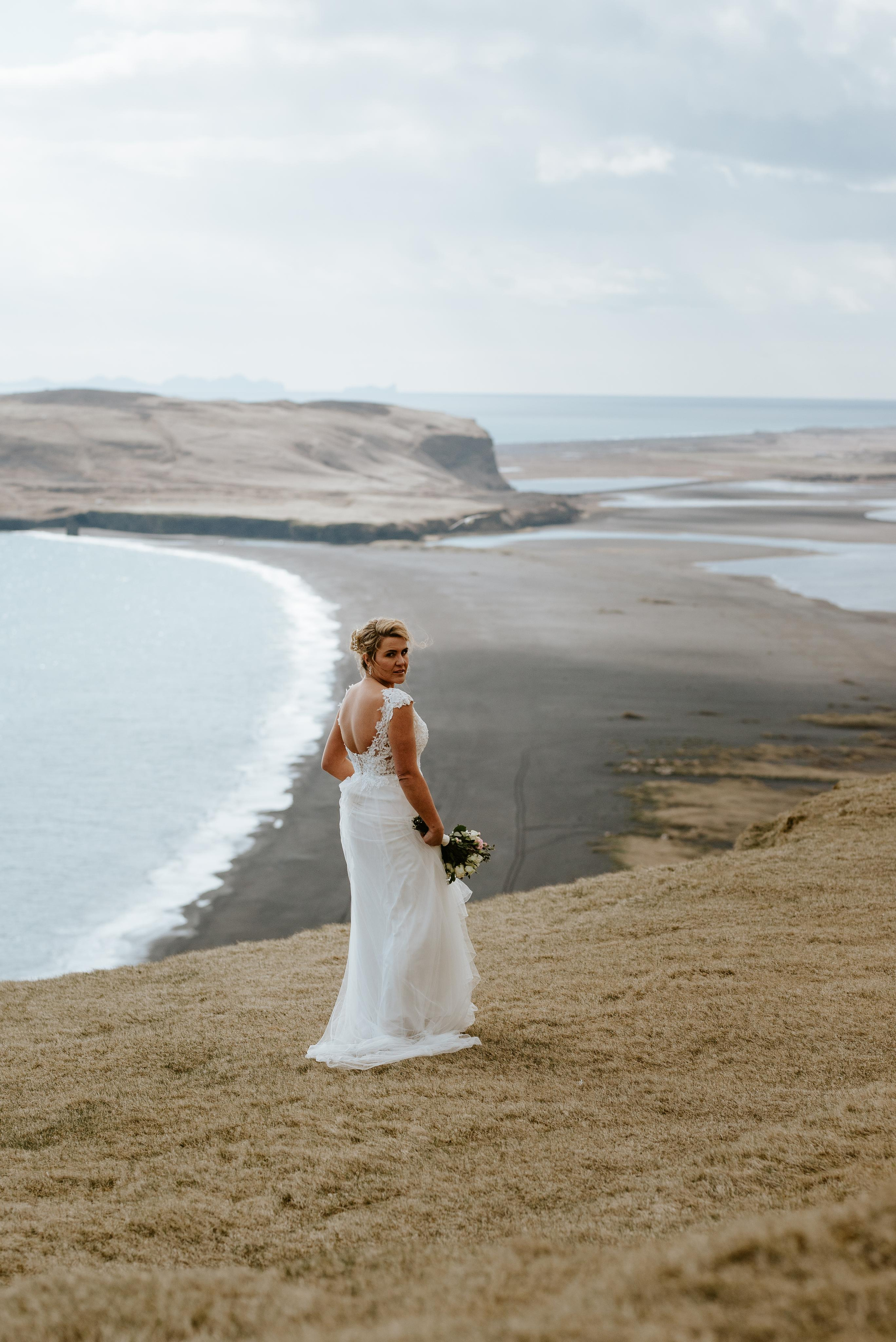 Silhouette of newlyweds against a glowing Icelandic sunset at Reynisfjara Beach