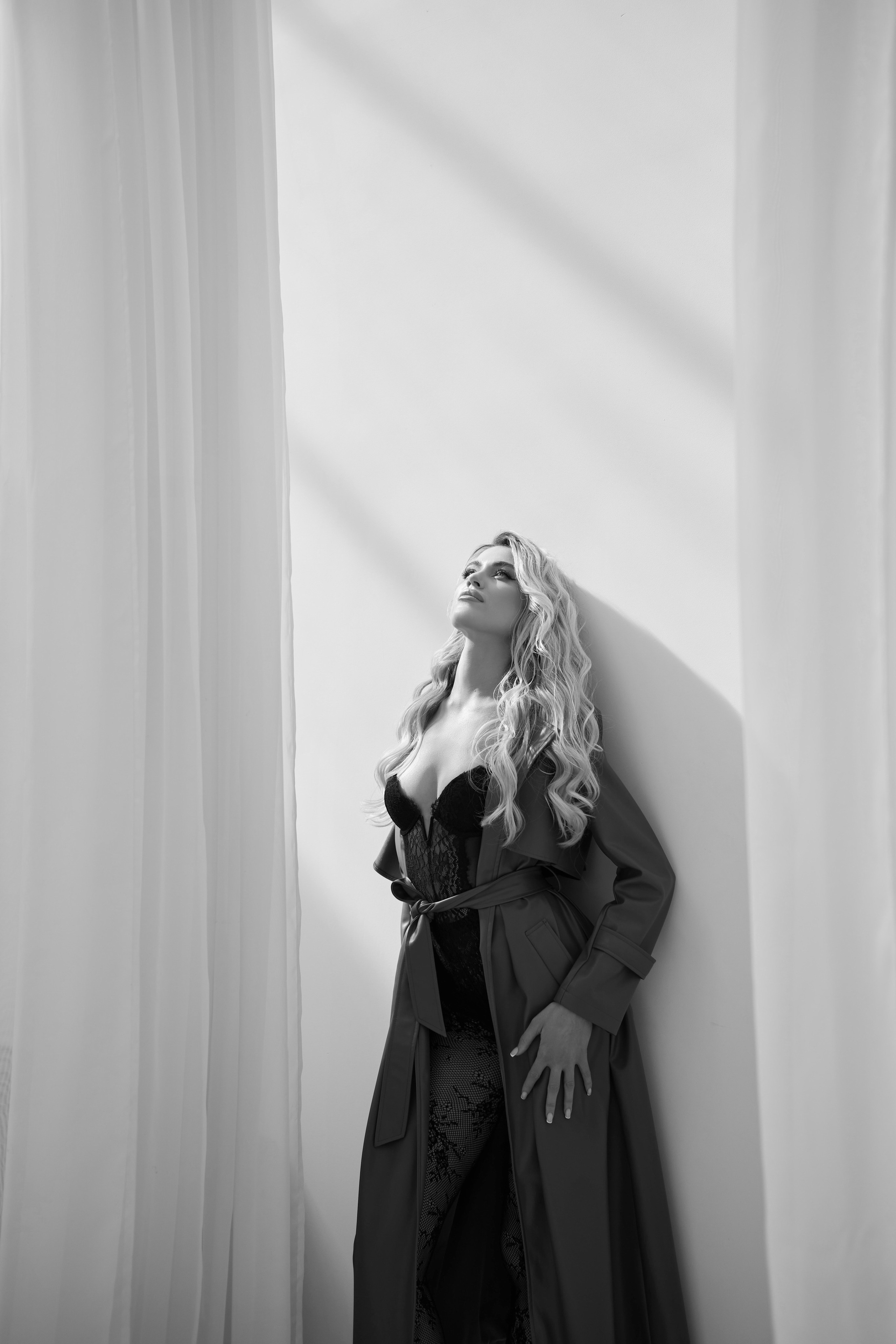 Simple and stylish portrait of model in white couture dress with natural window light Warsaw