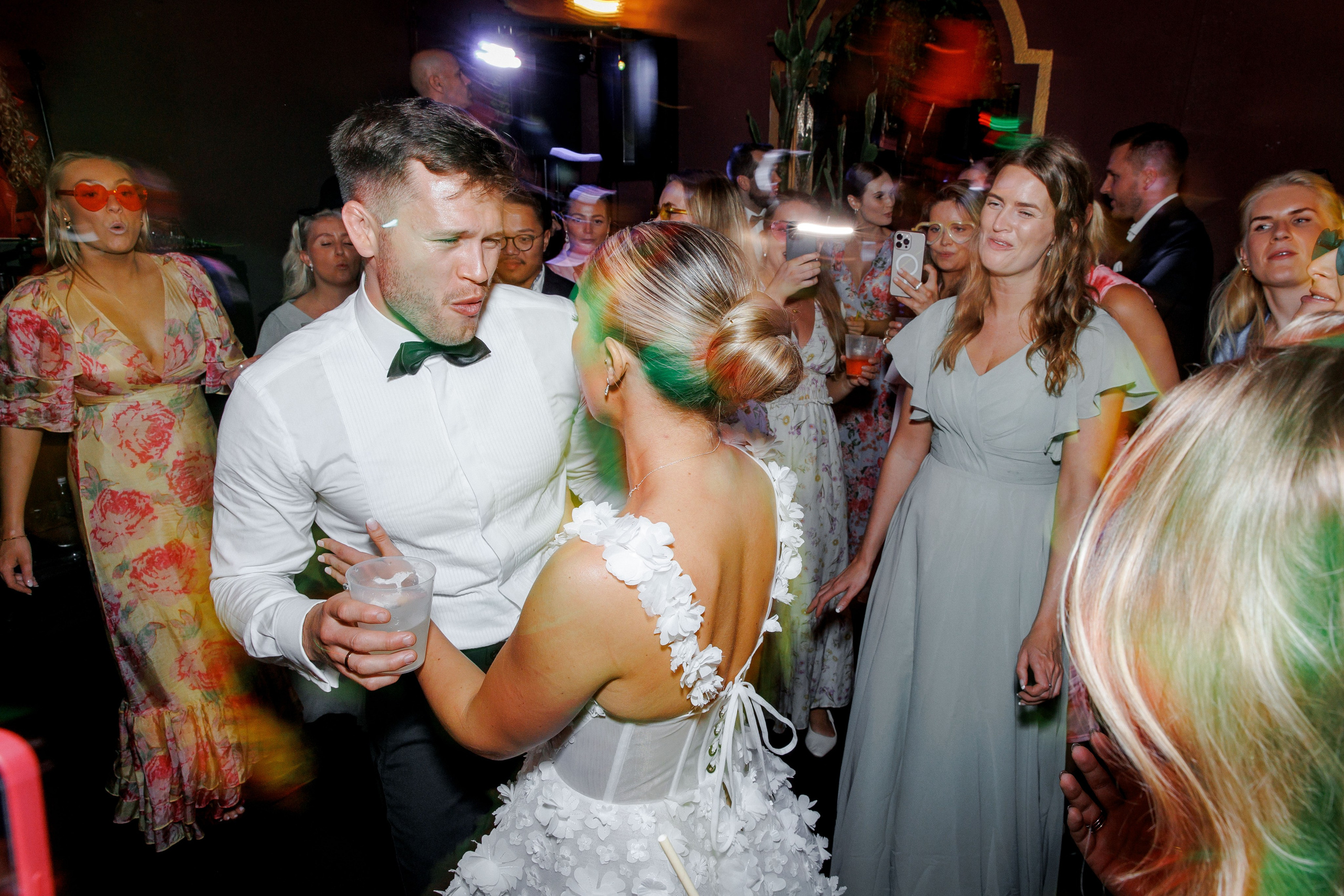 Newlyweds sharing their first dance at a Barcelona wedding, surrounded by family and friends in a joyous celebration.