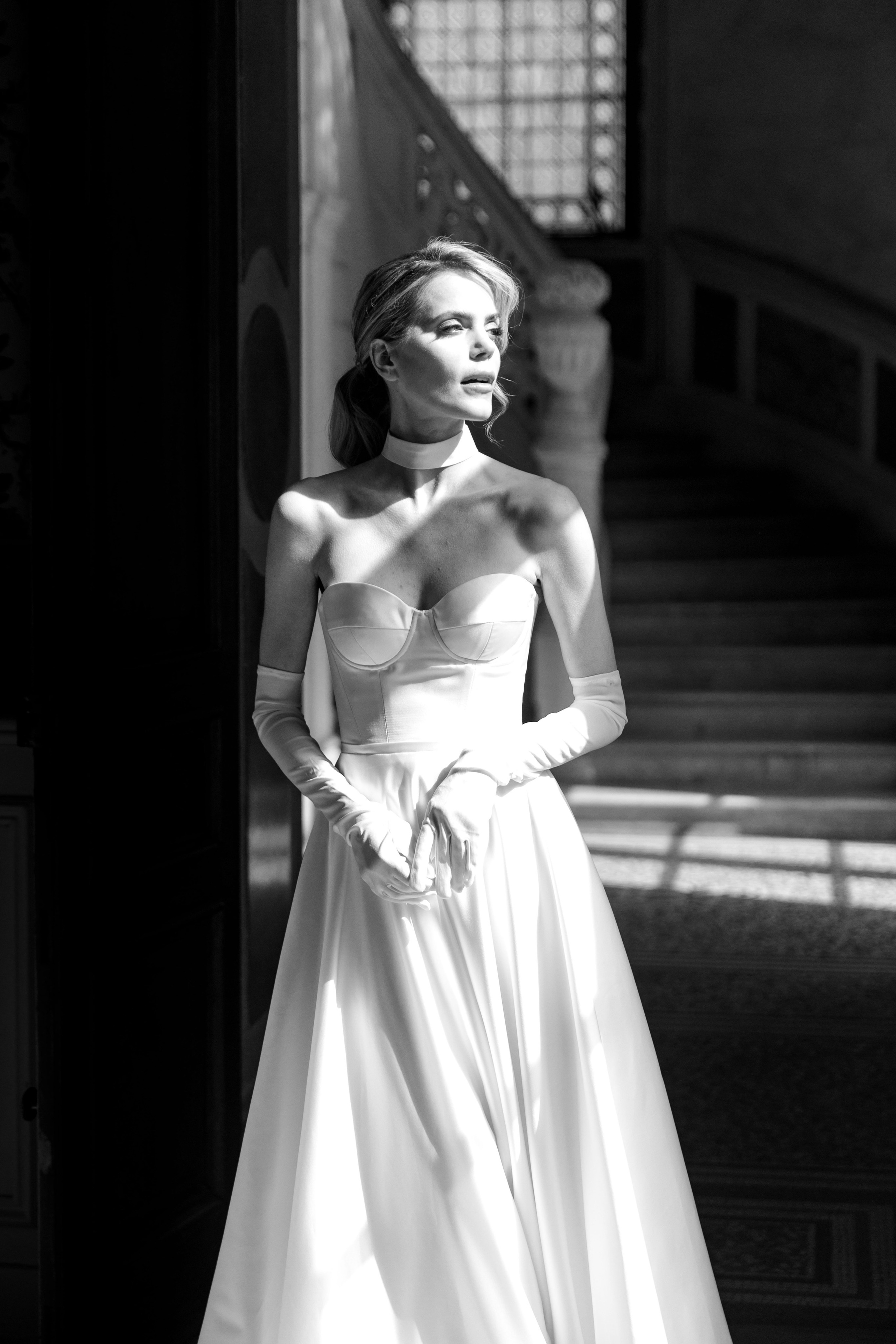 Emotional moment of the bride entering the room and meeting the groom in a French chateau for the wedding ceremony. 