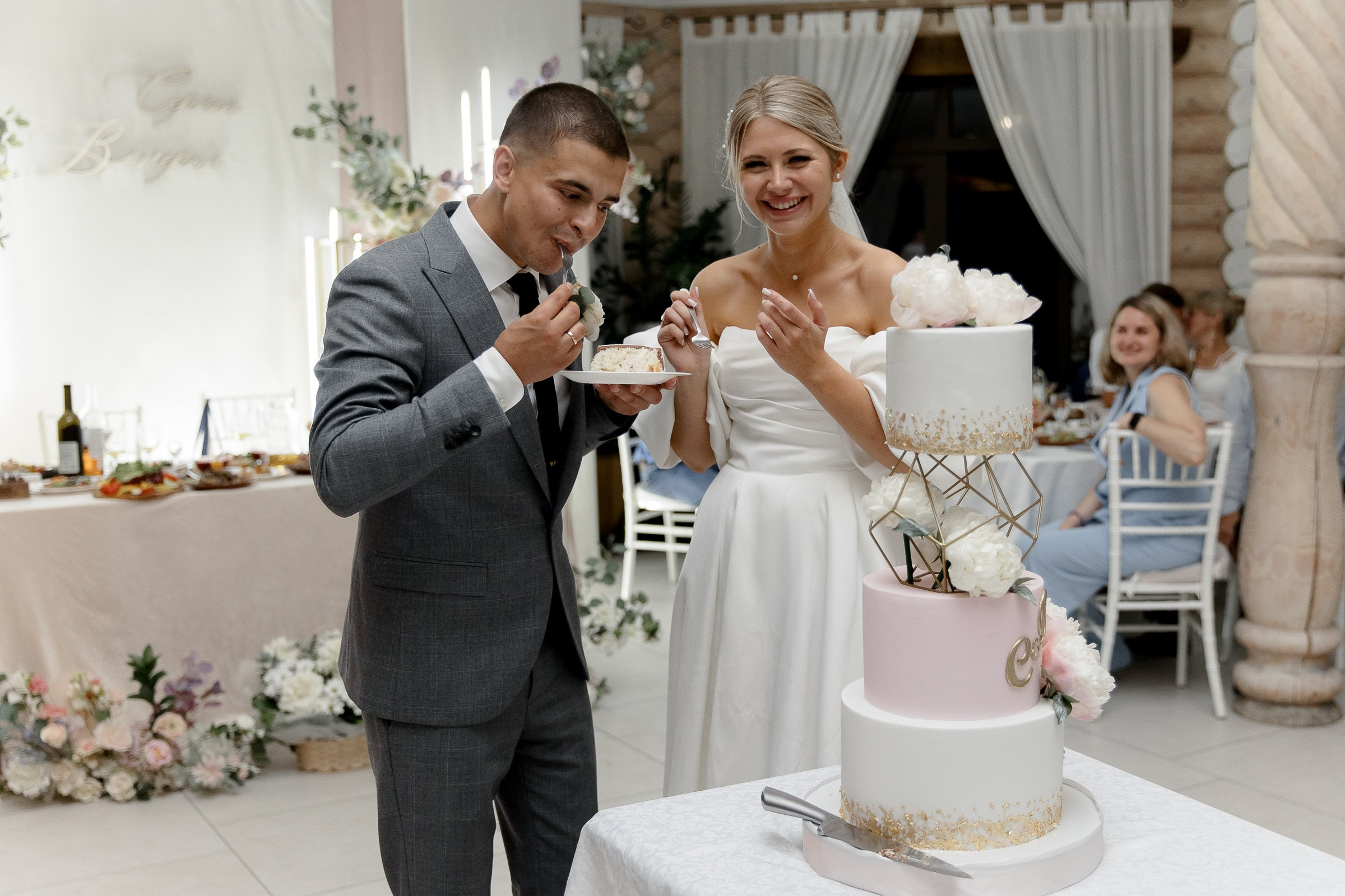 Couple eating the cake, by Devon wedding photographer.