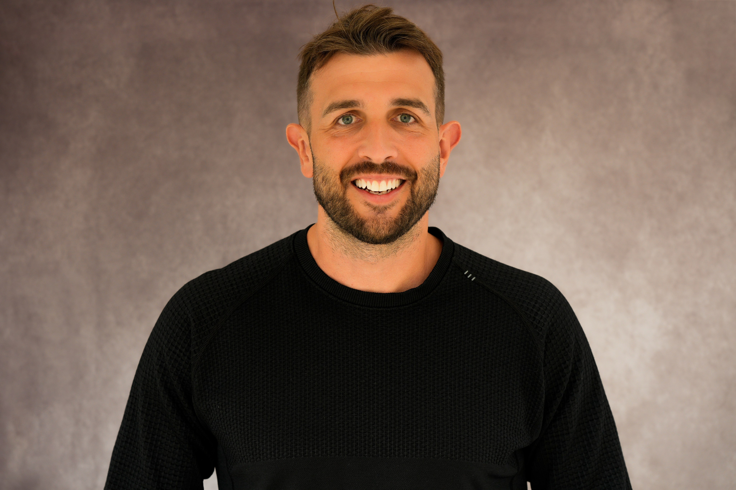 Professional headshot in Solihull of a young male in a white shirt, natural light highlighting his face