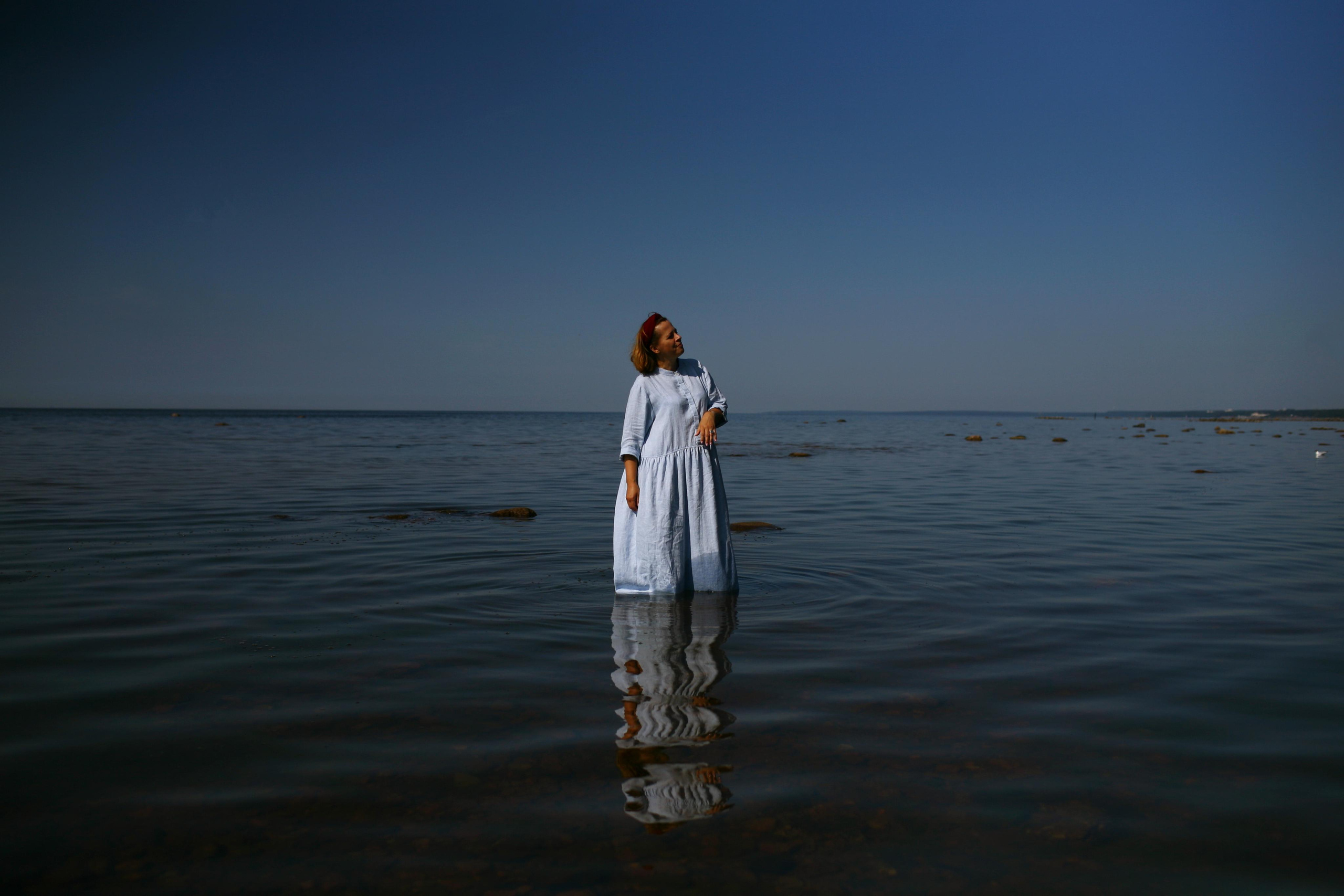 Anna, by herself. Stones and sand. Victoria Dini. Art photography in London / Folkestone, UK