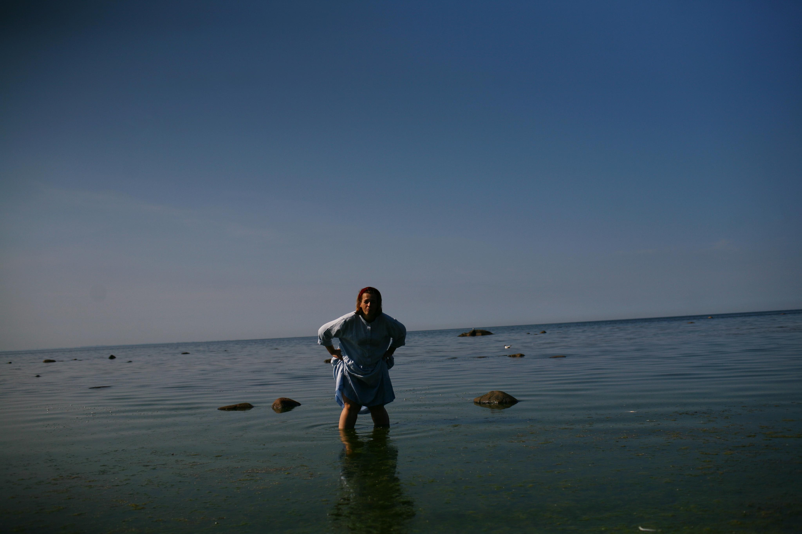 Anna, by herself. Stones and sand. Victoria Dini. Art photography in London / Folkestone, UK