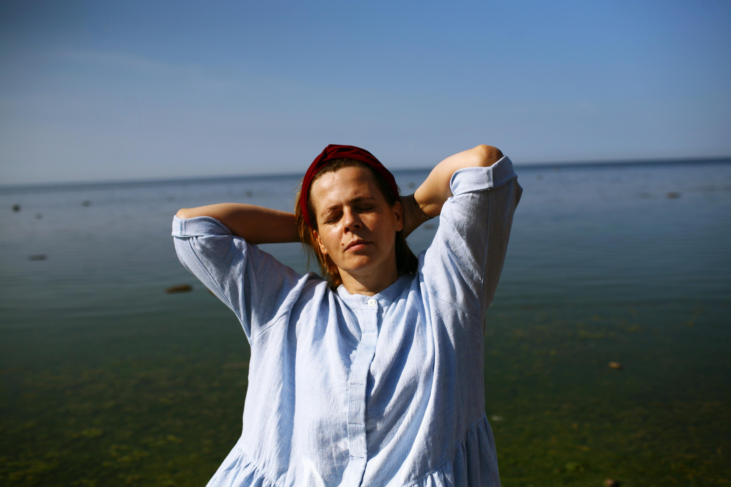 Anna, by herself. Stones and sand. Victoria Dini. Art photography in London / Folkestone, UK