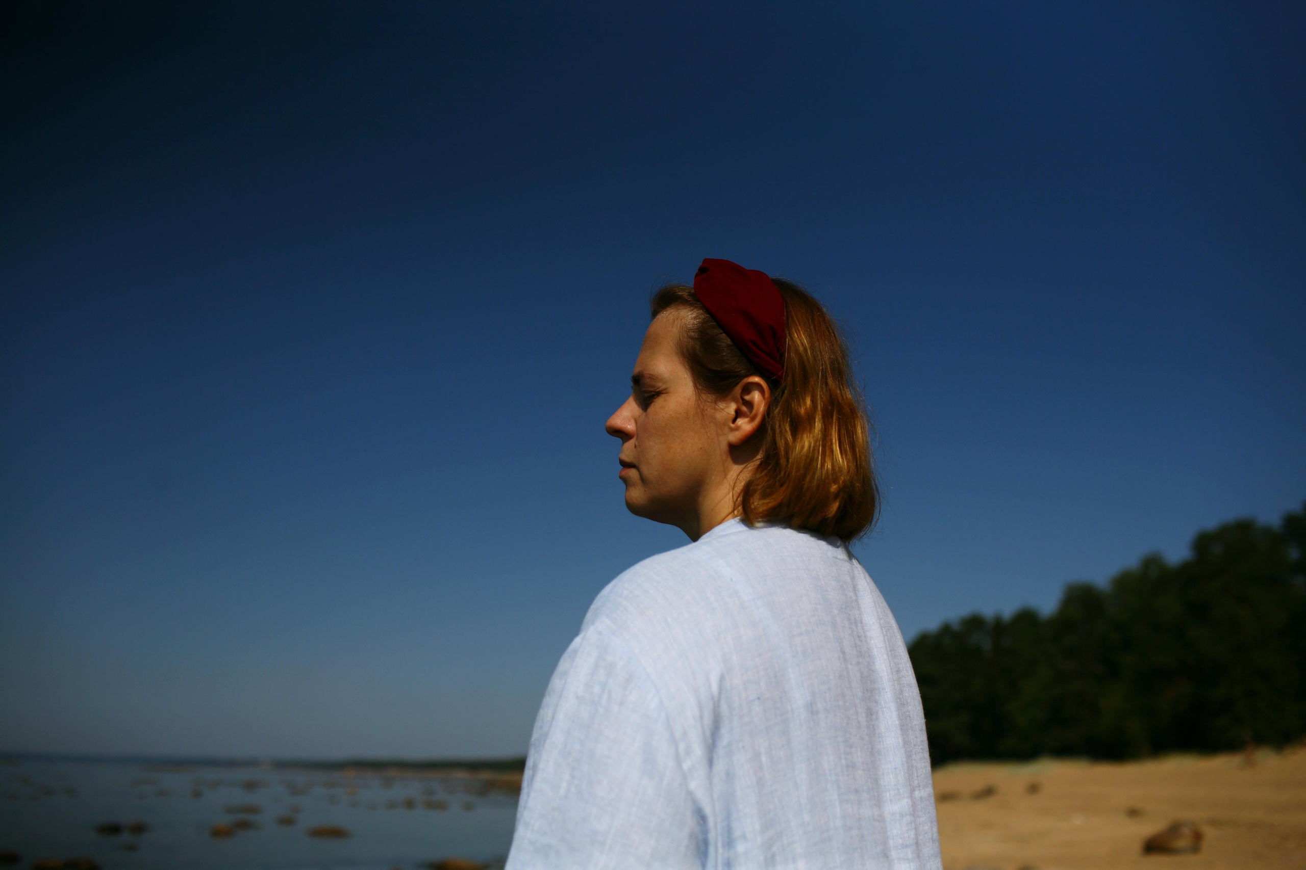 Anna, by herself. Stones and sand. Victoria Dini. Art photography in London / Folkestone, UK
