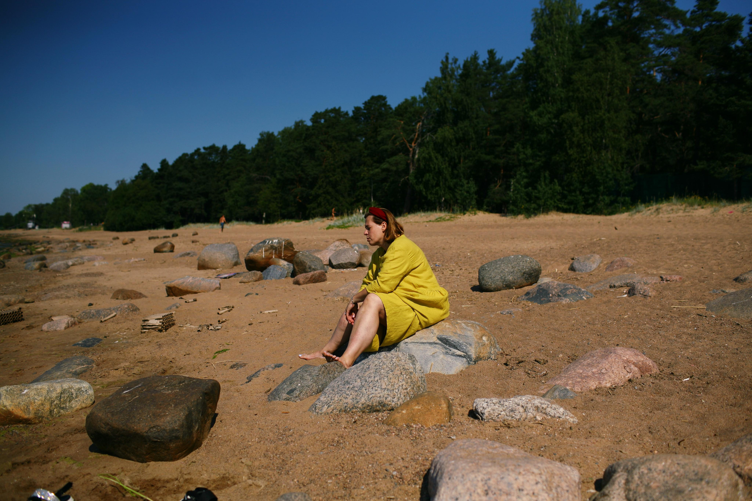Anna, by herself. Stones and sand. Victoria Dini. Art photography in London / Folkestone, UK