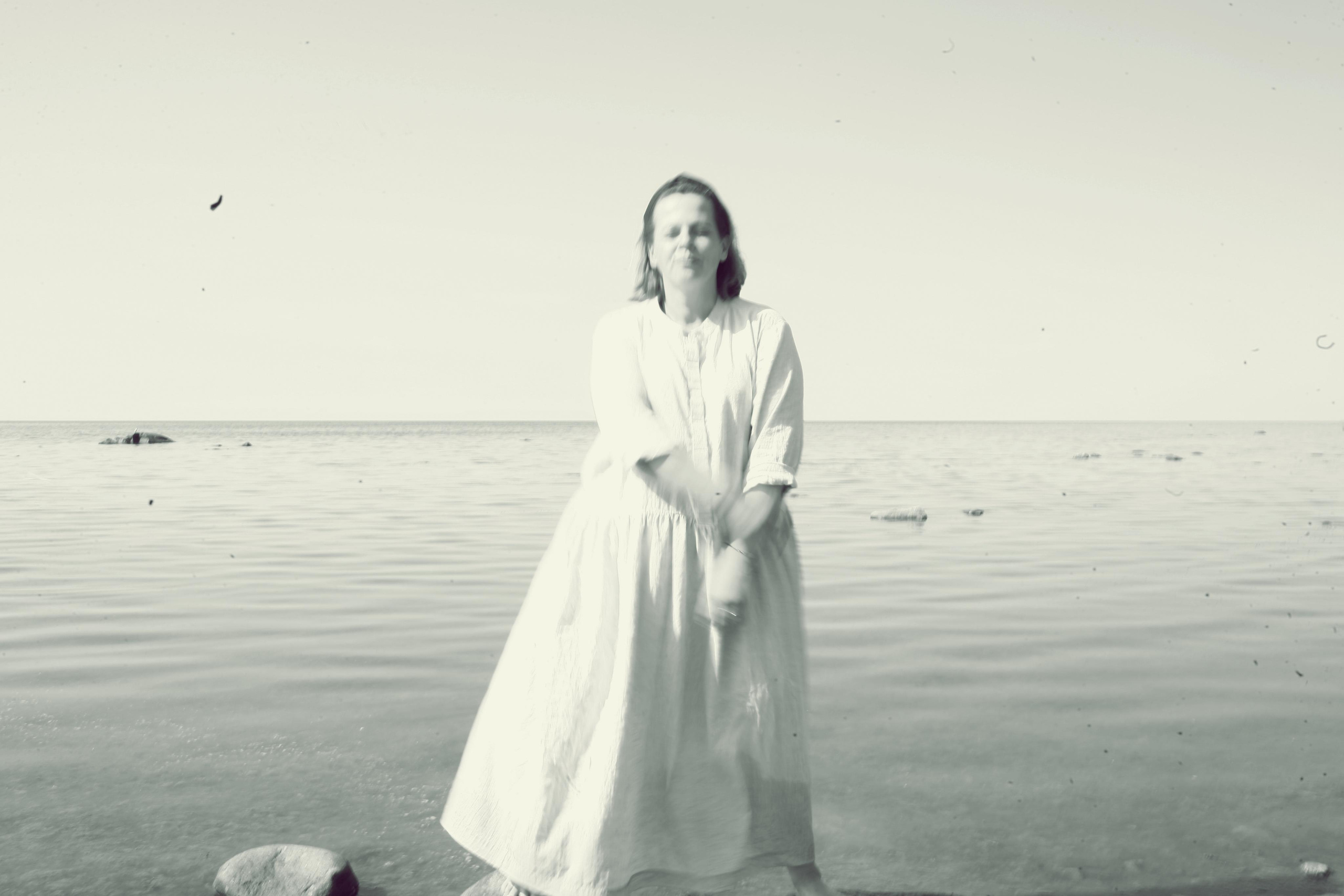 Anna, by herself. Stones and sand. Victoria Dini. Art photography in London / Folkestone, UK