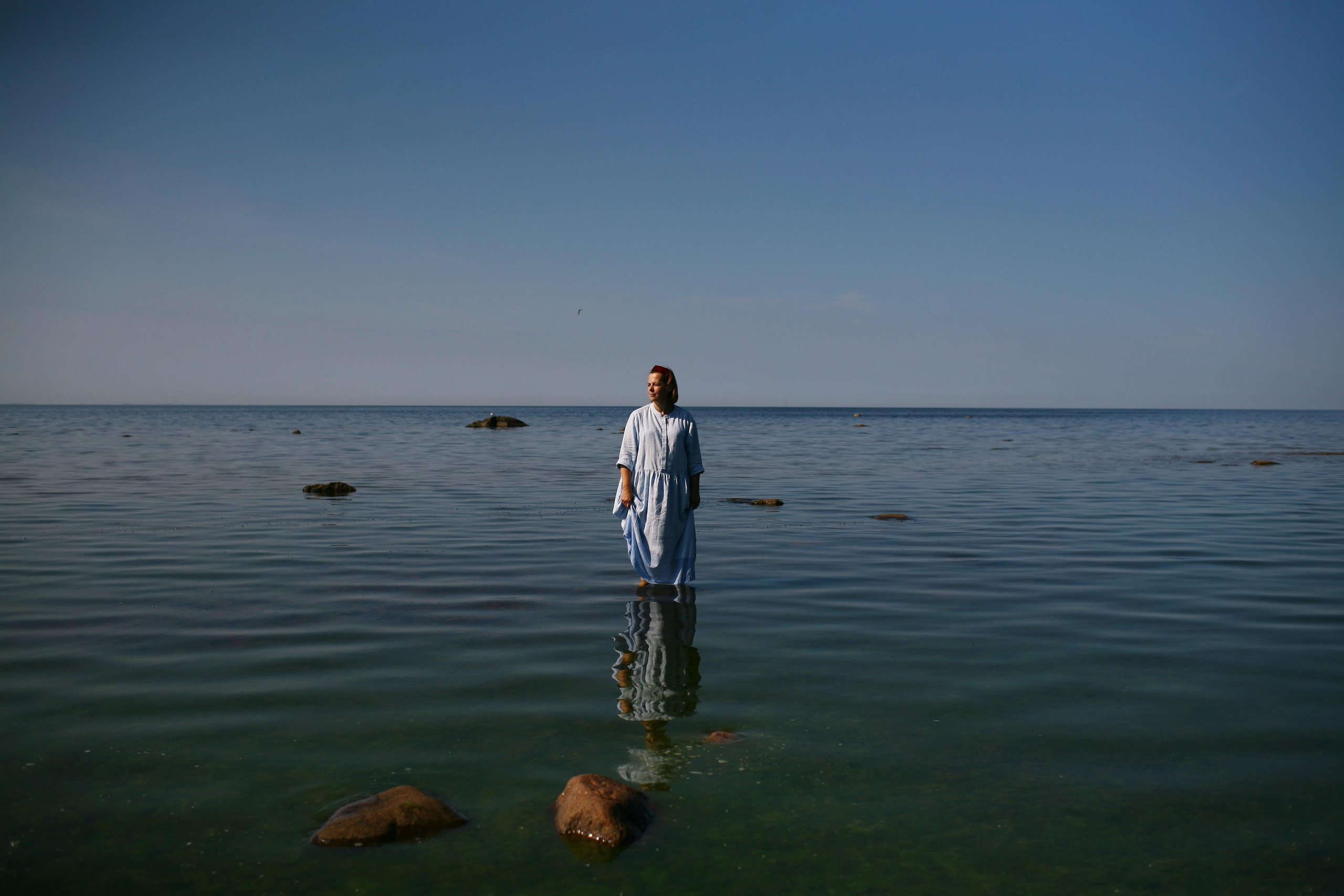 Anna, by herself. Stones and sand. Victoria Dini. Art photography in London / Folkestone, UK