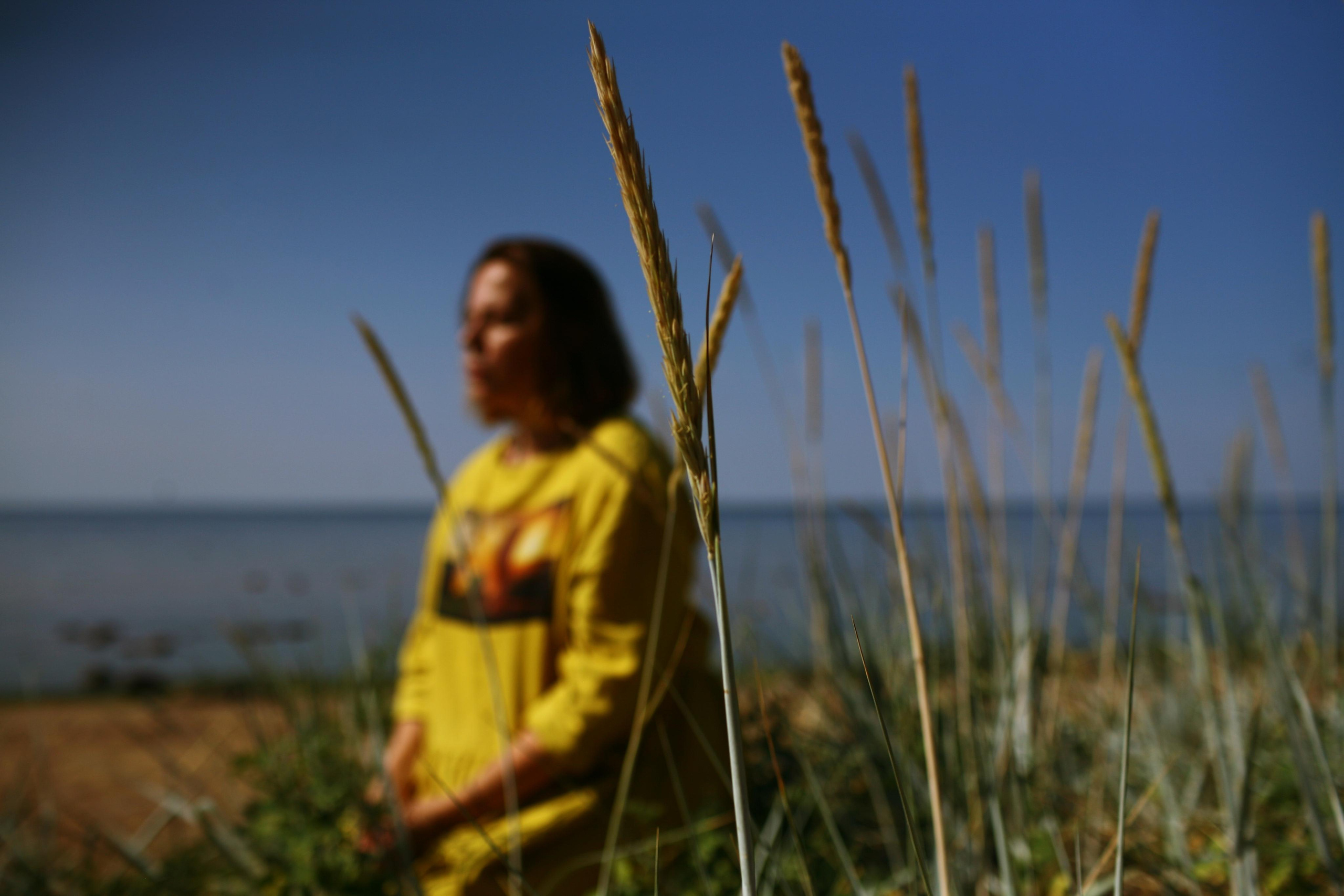 Anna, by herself. Stones and sand. Victoria Dini. Art photography in London / Folkestone, UK