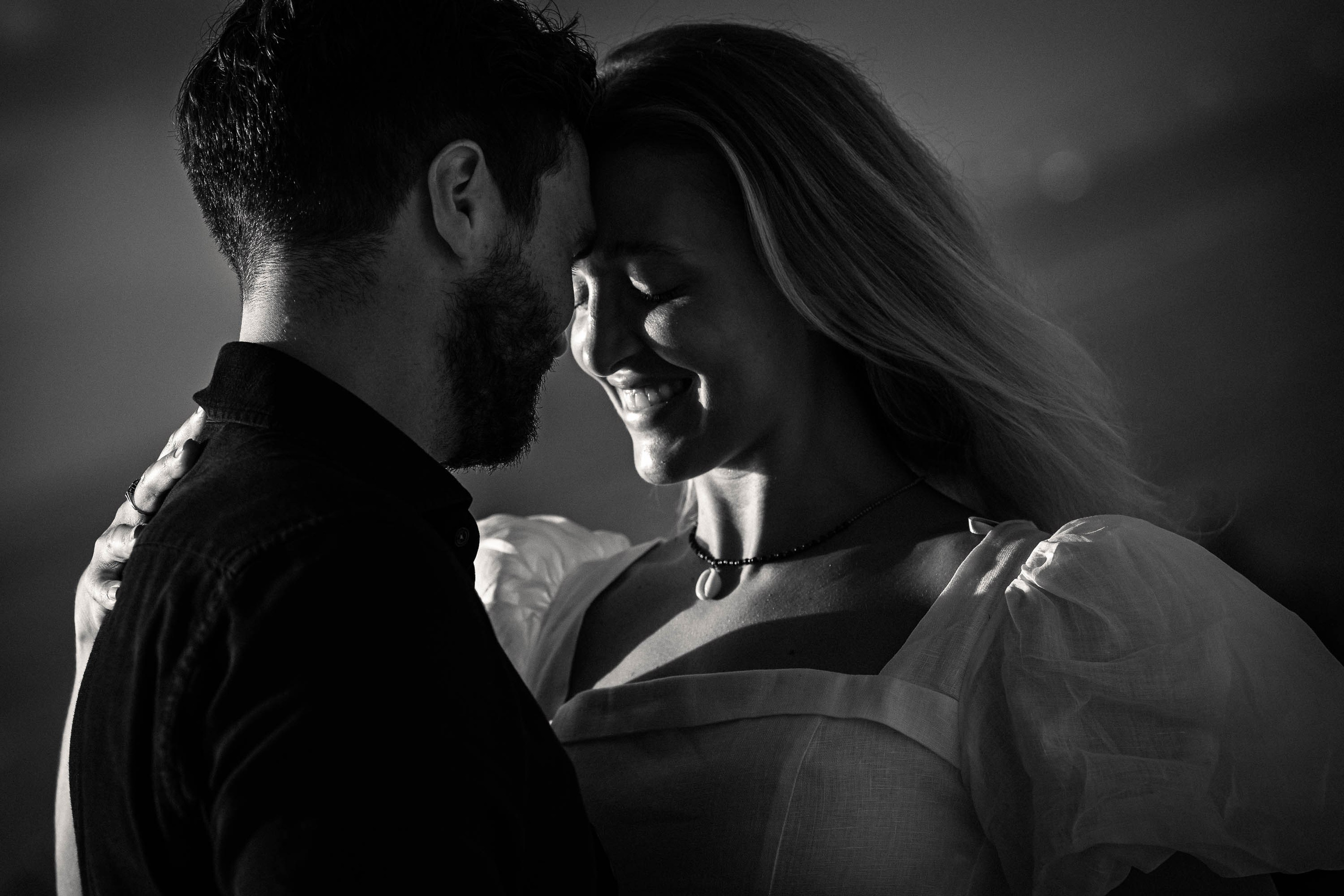 Couple in black and white dance, smile and celebrate their proposal at the Cap Rocat Venue.