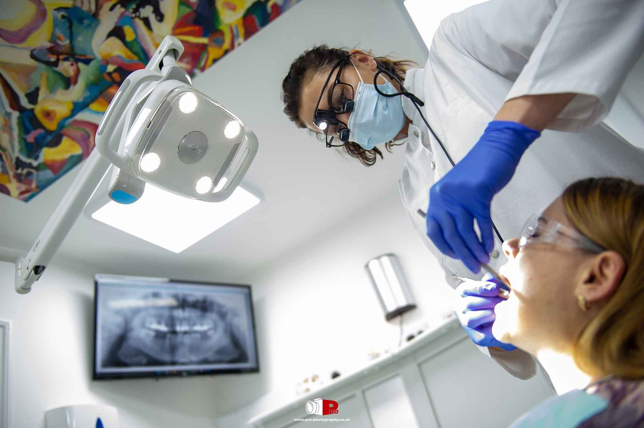 Dentist performing a dental procedure in a clean, modern clinic setting with advanced equipment.