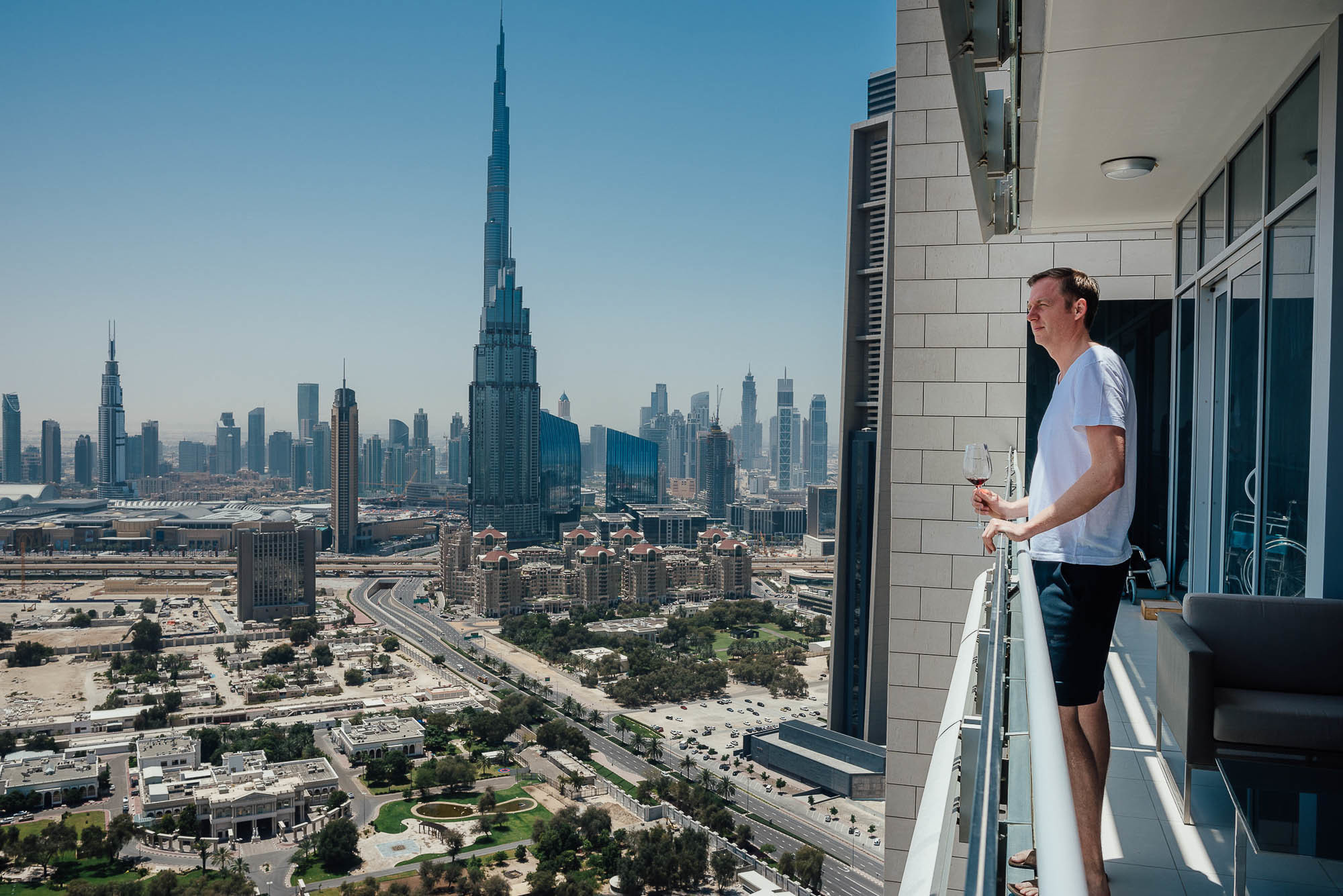 Мужчина с бокалом вина на балконе, Дубаи, ОАЭ