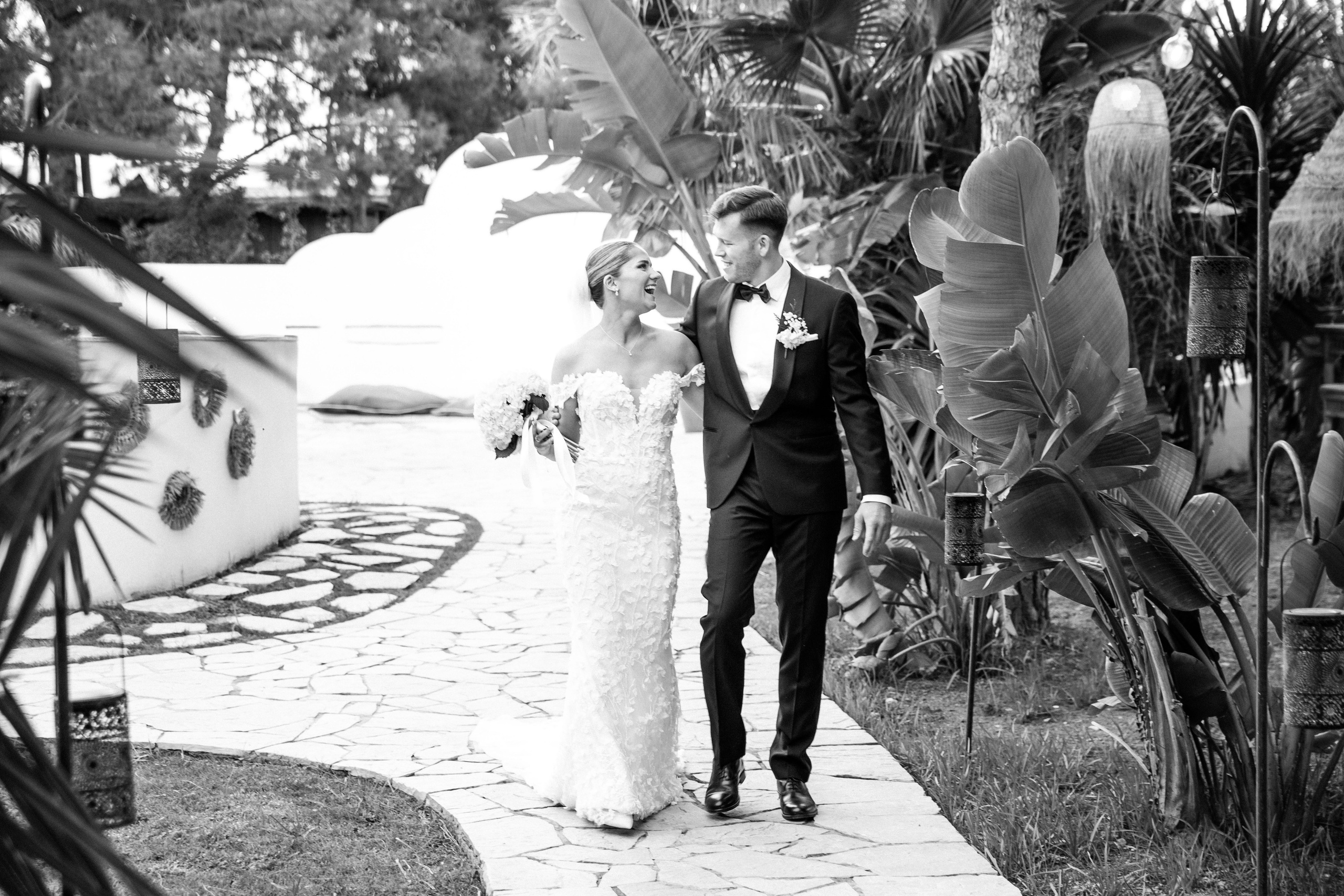 Intimate moment of the bride and groom sharing a laugh during their wedding photo session in Spain.