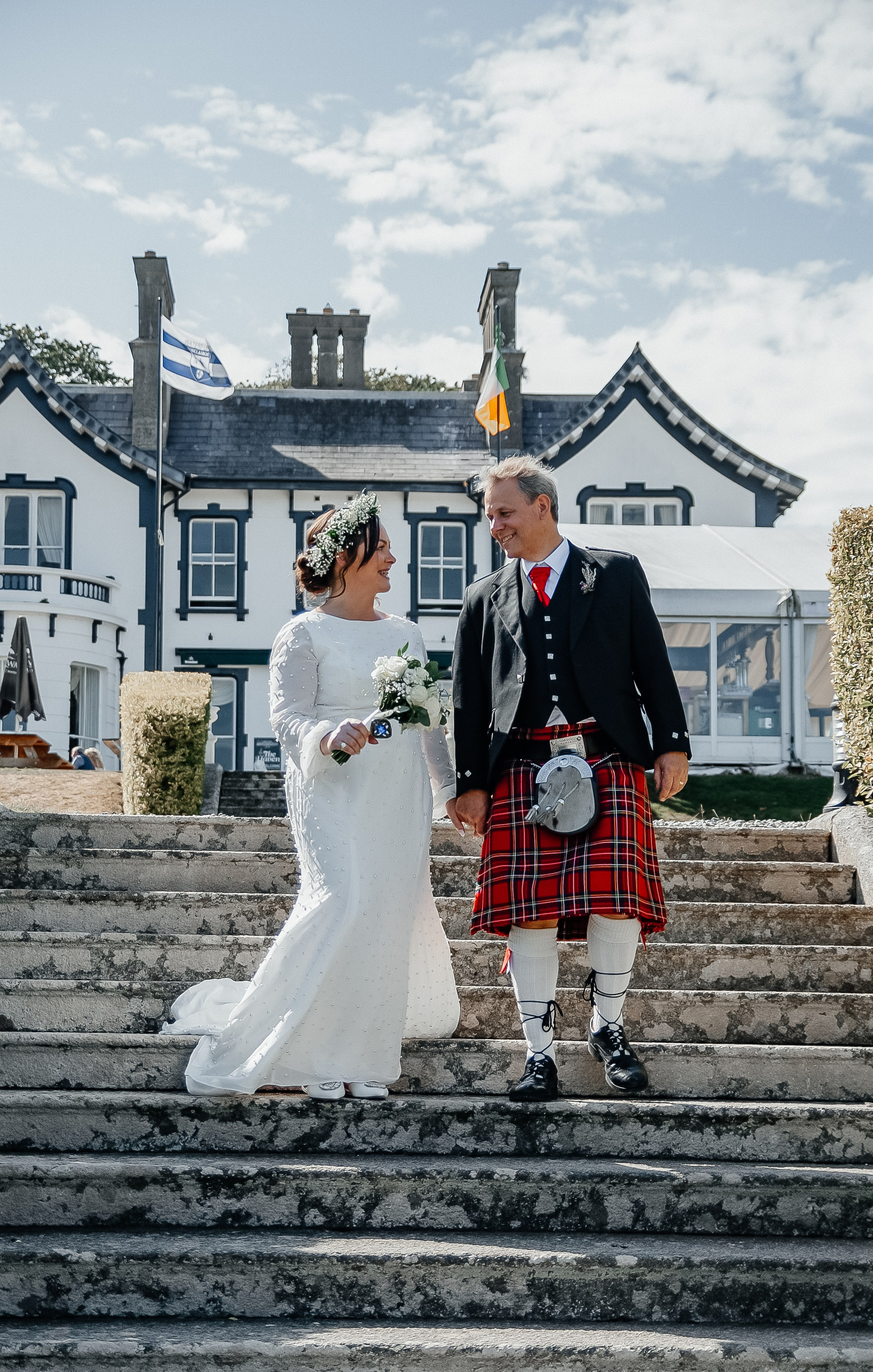 Happy couple walking down at Waterford wedding