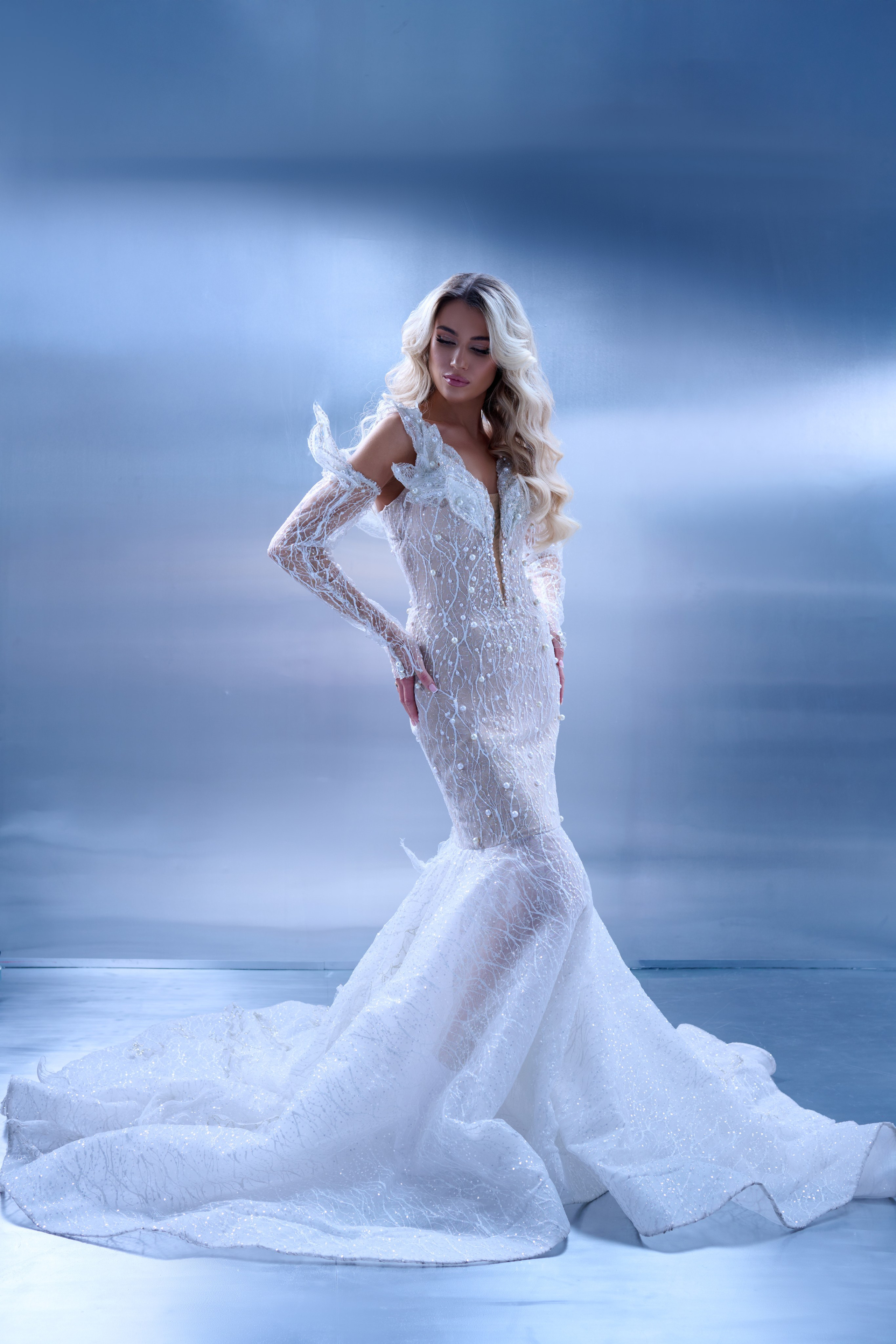 Studio glamour photography of elegant woman in couture dress with blowing hair Warsaw