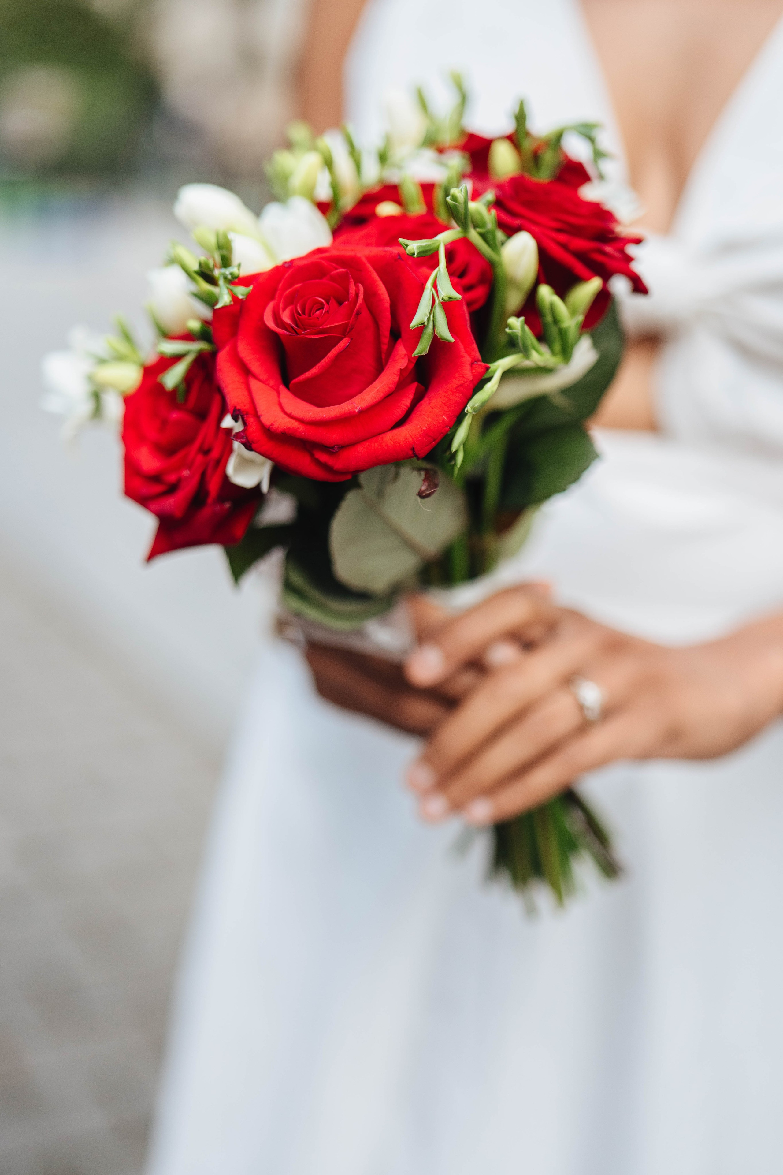 Wedding photography in london, bride close up, red flowers