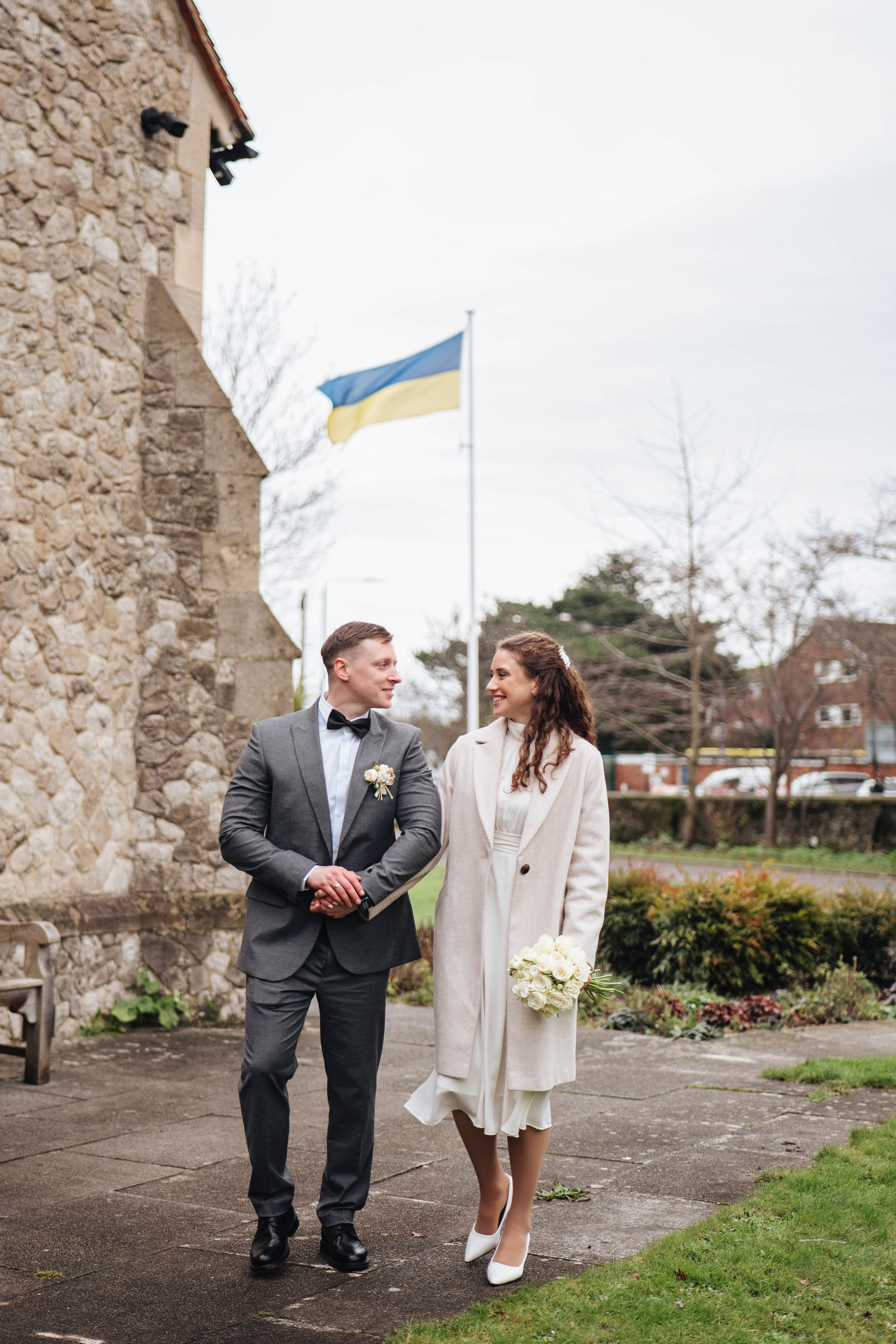 bride and groom with ukrainian flag on the background