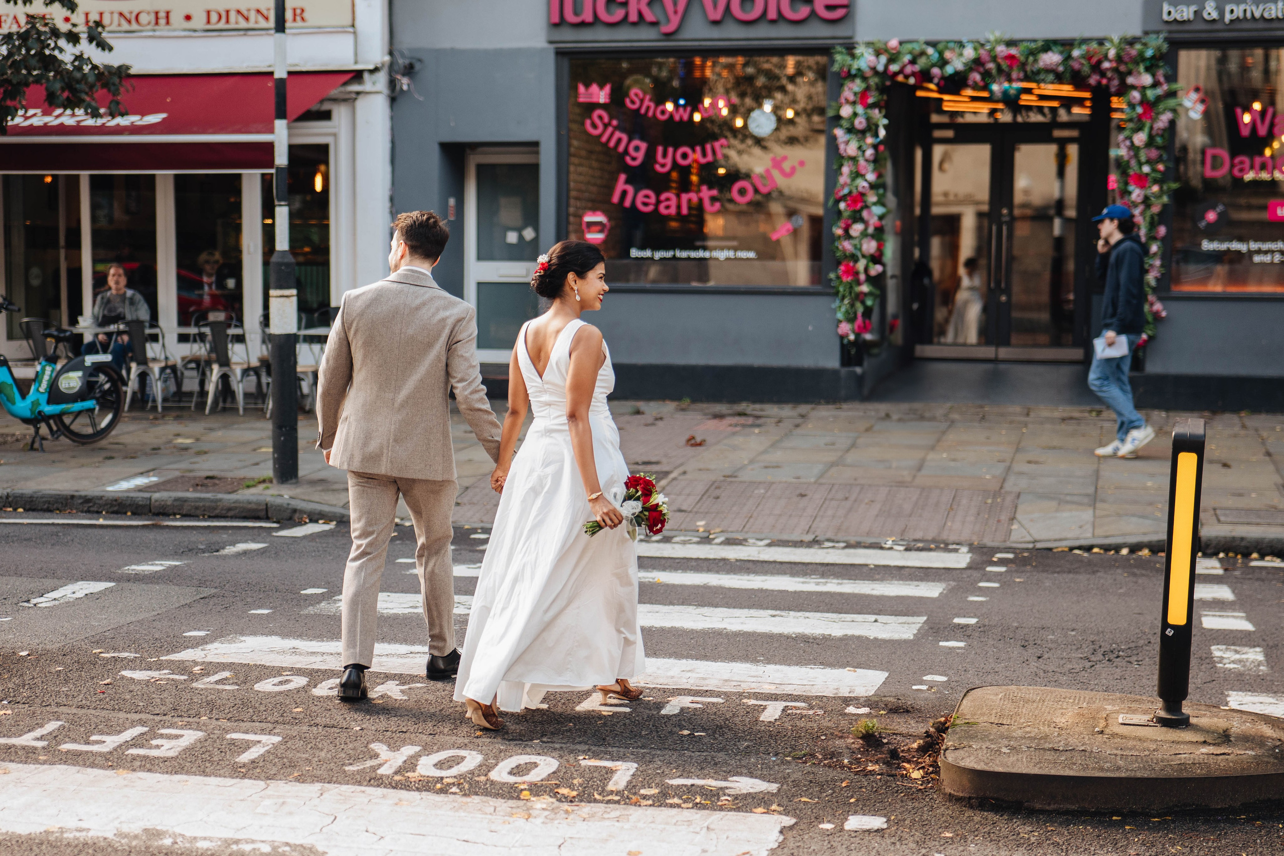 Wedding couple on the road crossing in Islington near Islington town hall