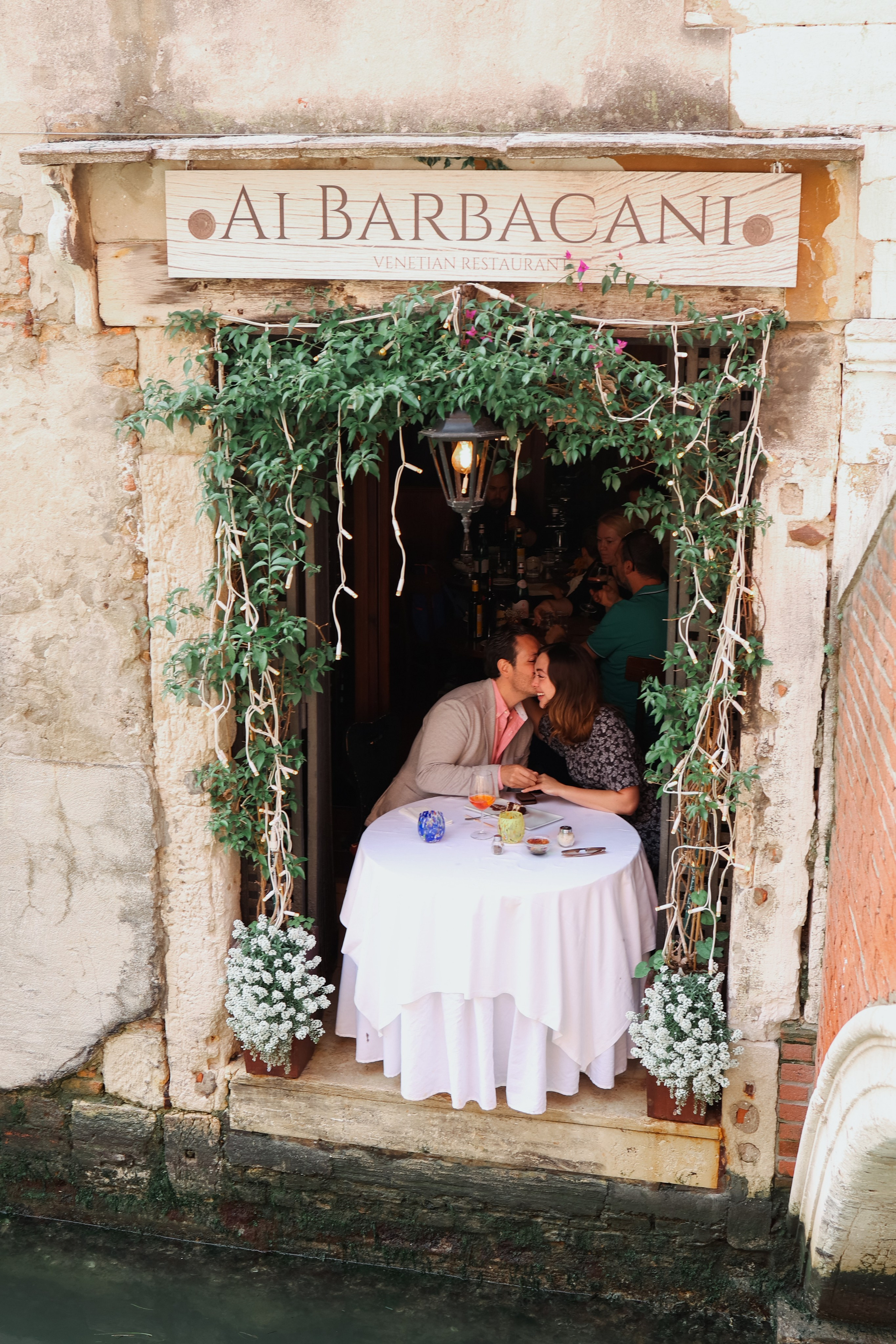 A Fairytale Proposal - Seated at an intimate table in Barbacani, a couple shares a once-in-a-lifetime moment as he asks the question that changes everything