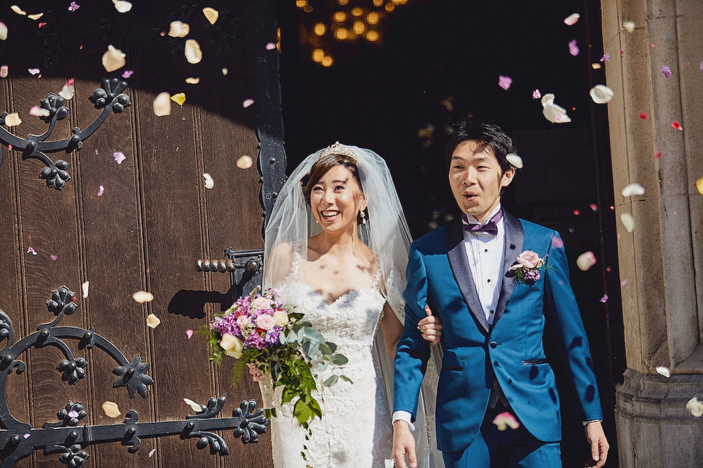 Newlyweds showered with rose petals in a traditional celebration outside St. Martin's Church.T