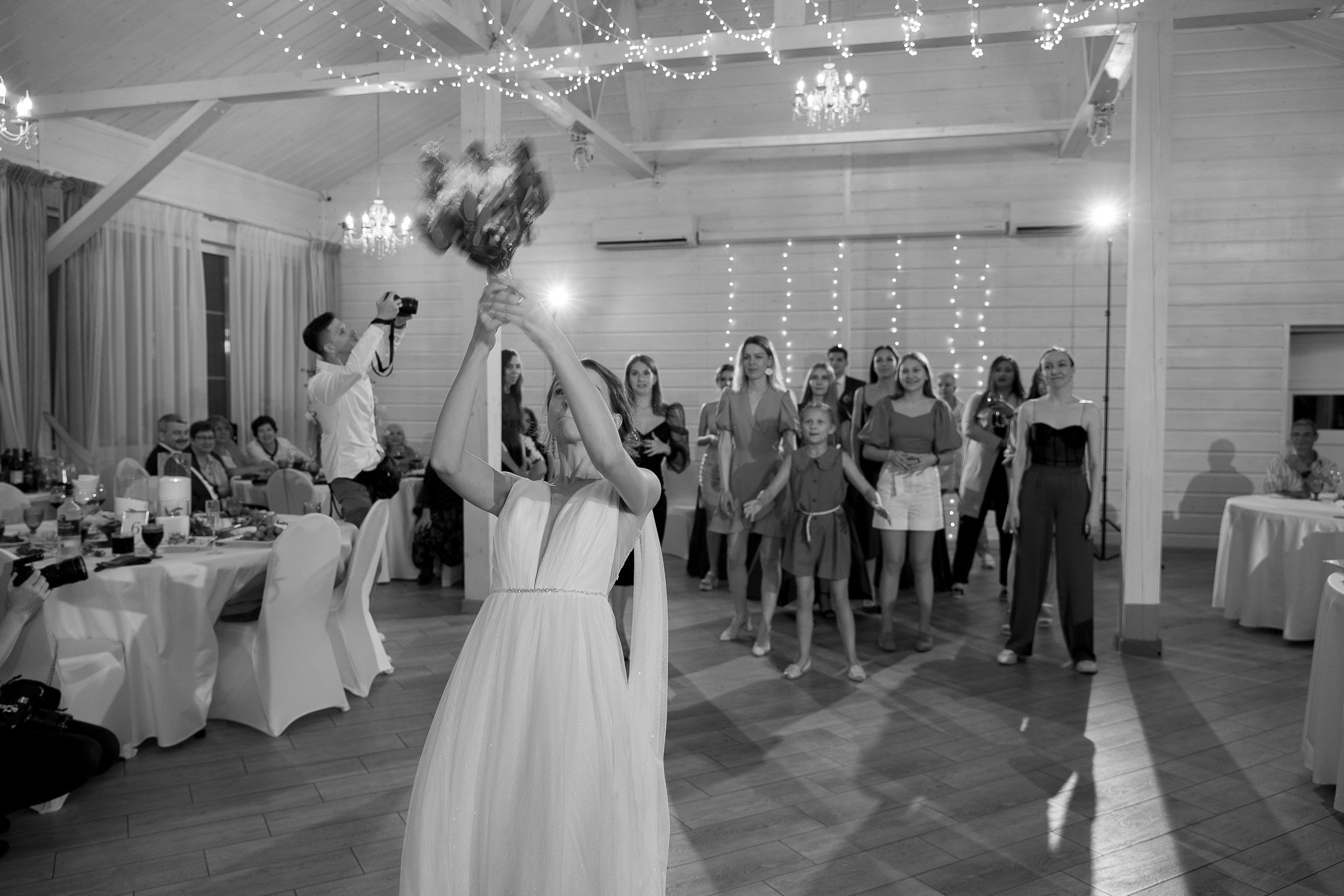 Bride tossing bouquet at reception, by Bude, Cornwall reportage photographer.