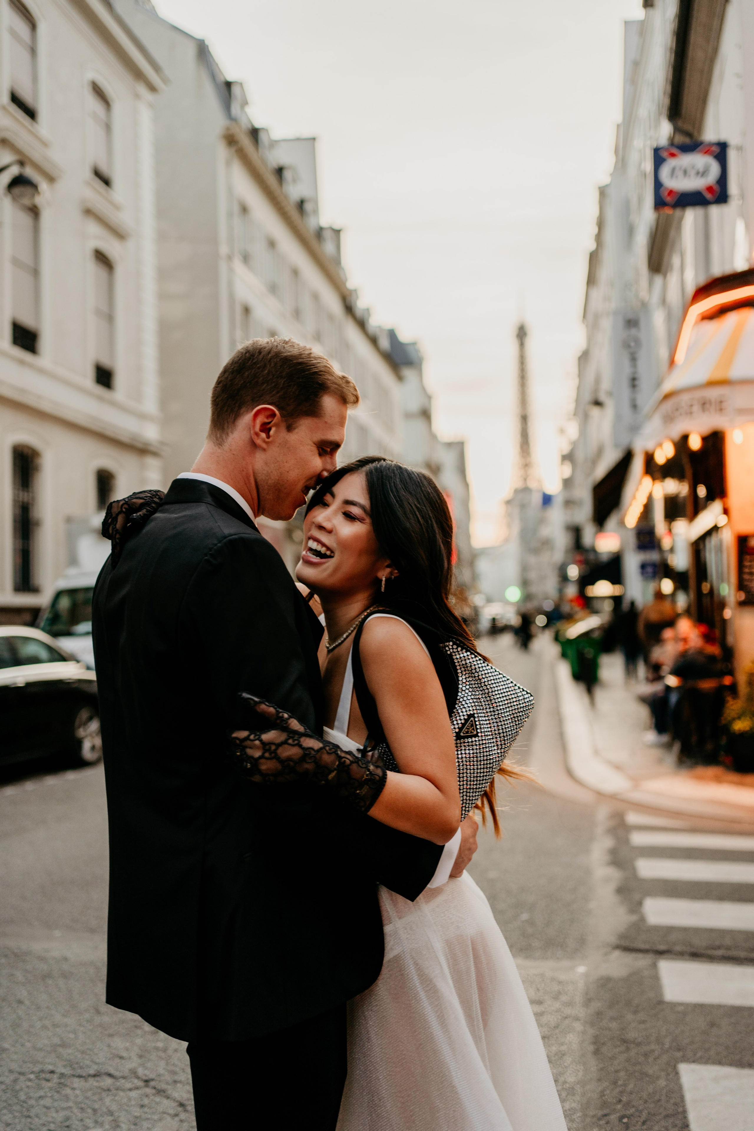 Stylish couple during sunset laughing in Paris