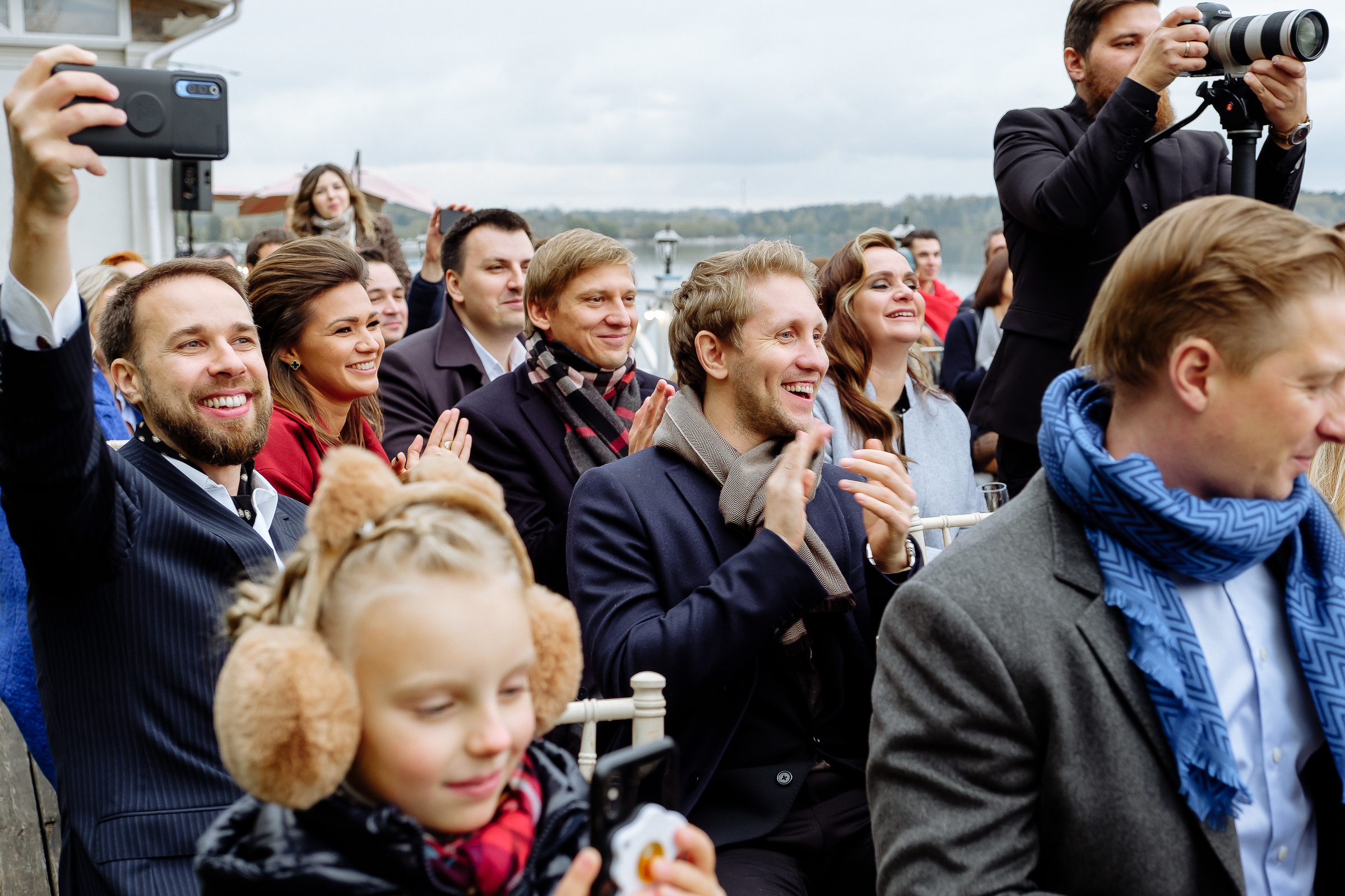 Guests clapping by riverside, by Tanya Bodgan, Bude wedding photographer.