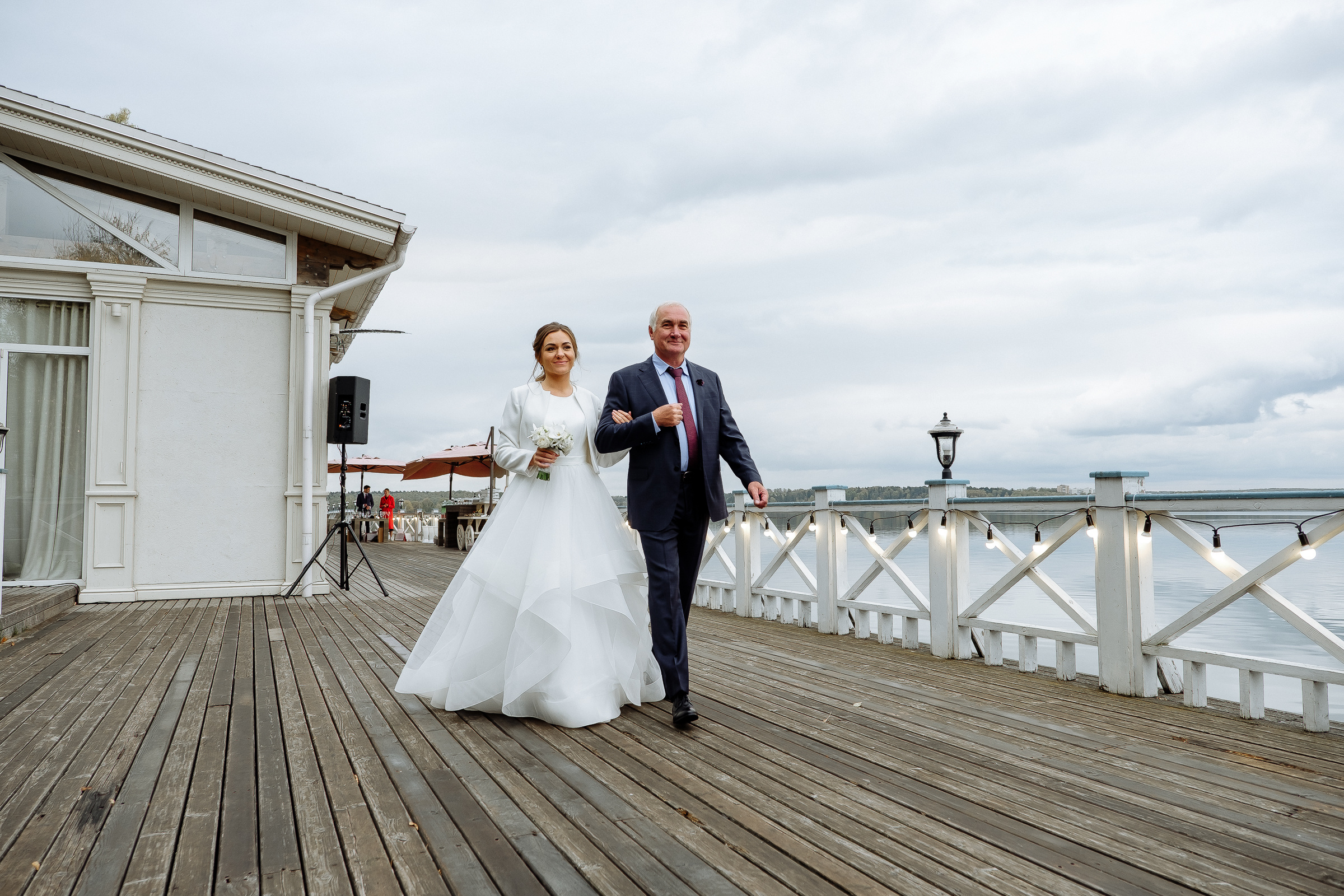 Bride walking down riverside aisle, by Tanya Bodgan, Bude, Cornwall wedding photographer.