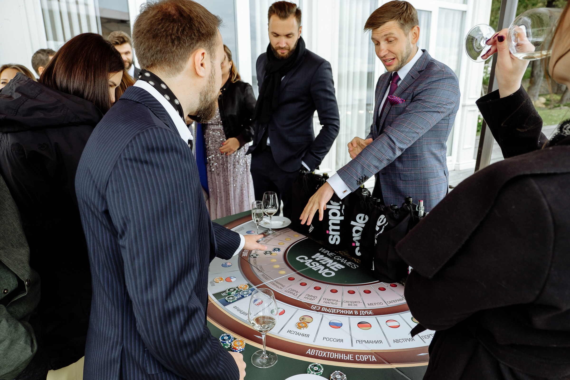 Guests with casino chips on riverboat, by Tanya Bodgan, Truro editorial wedding photographer.  