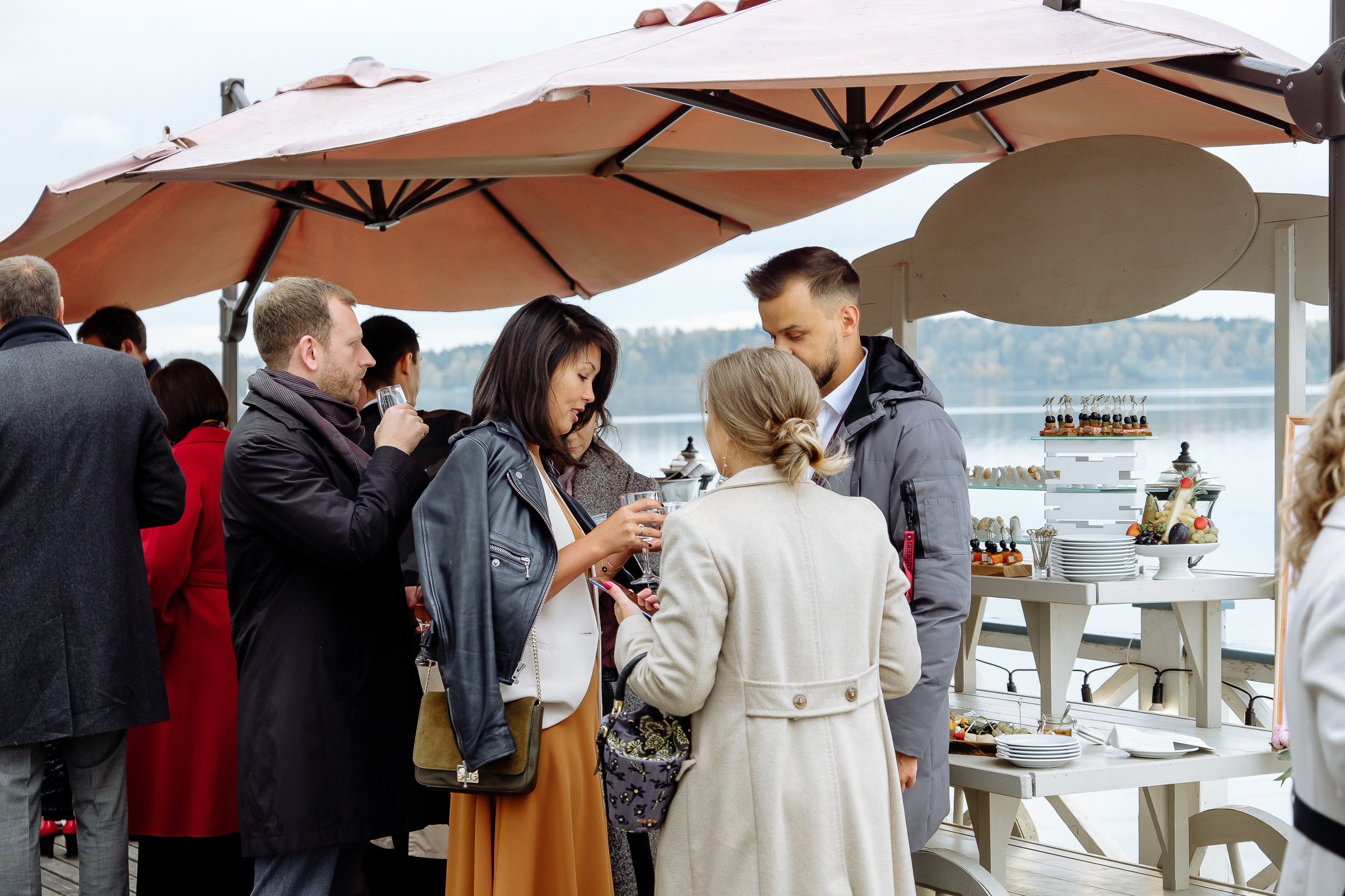 Guests on riverboat deck with drinks, by Tanya Bodgan, Bude, Cornwall wedding photographer.  