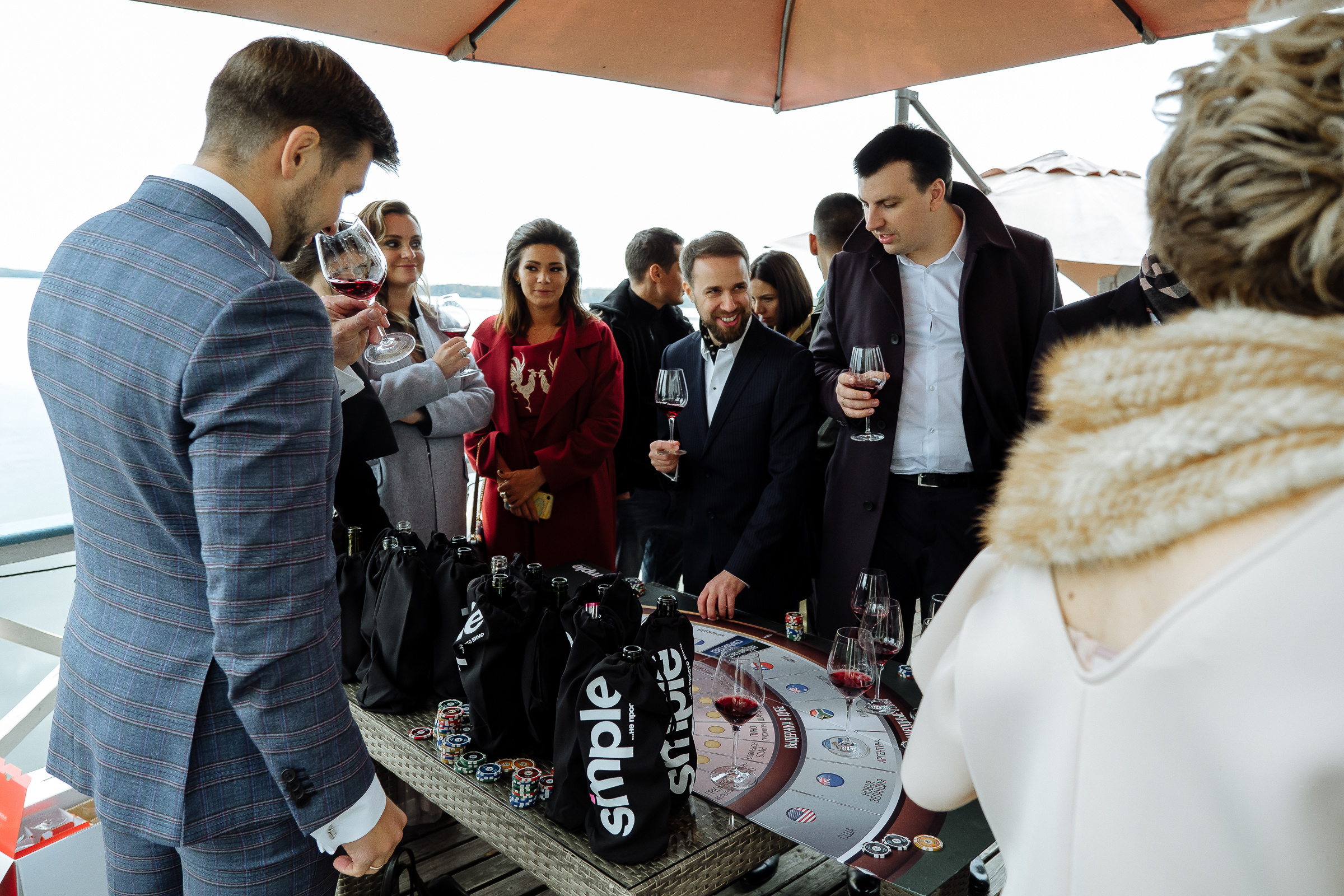 Guests on riverboat deck casino, by Tanya Bodgan, Bude, Cornwall wedding photographer.  
