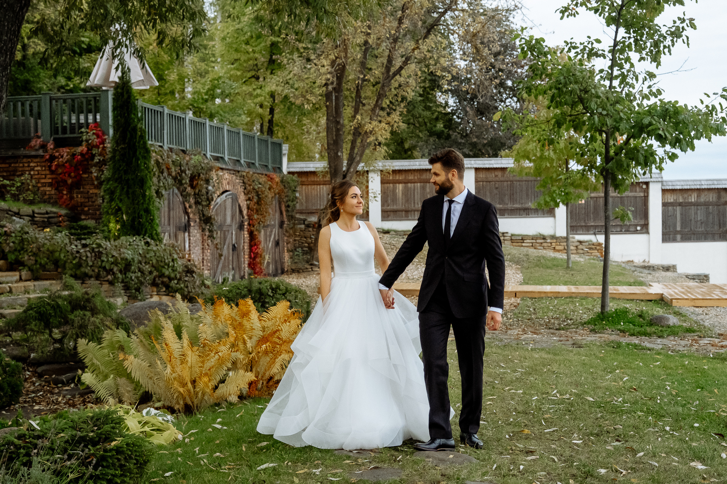 Bride and groom garden candid, by Tanya Bodgan, Falmouth reportage wedding photographer.