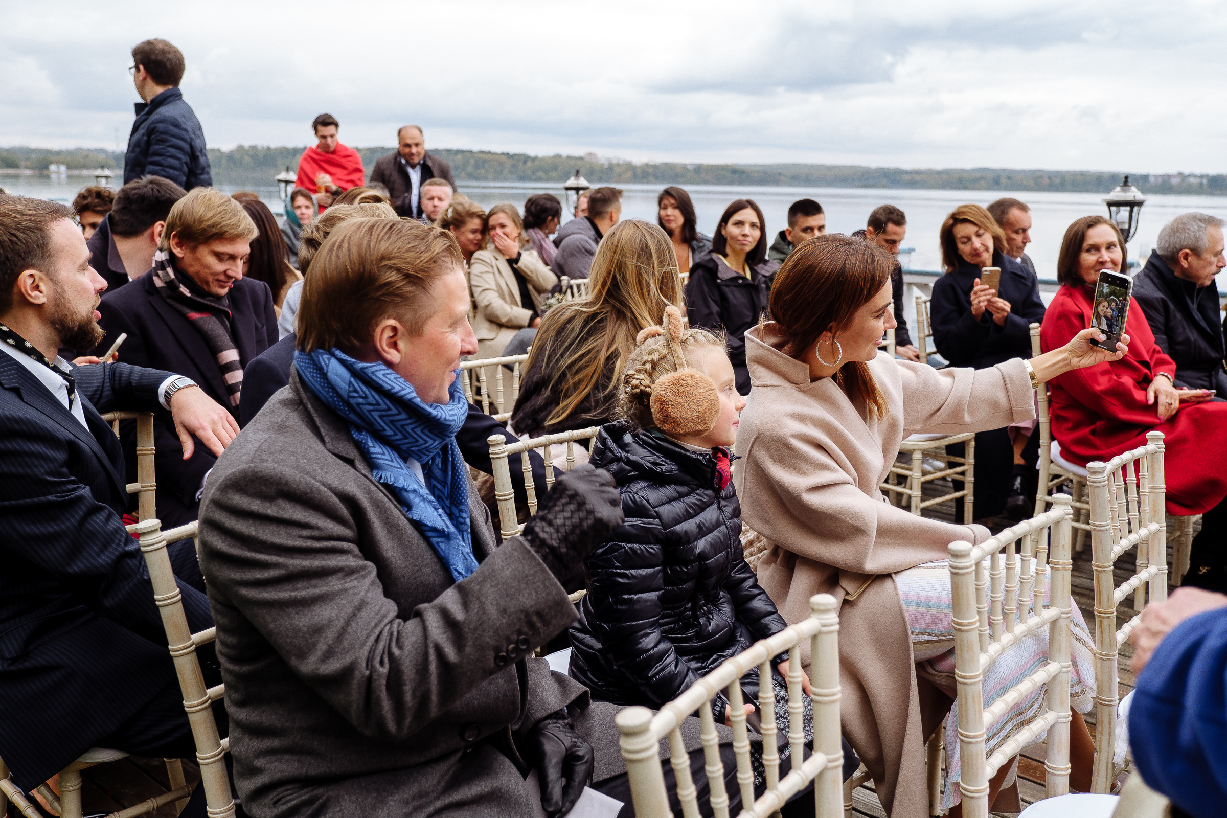 Guests sitting at ceremony on riverboat deck, by Tanya Bodgan, Bude, Cornwall wedding photographer.  