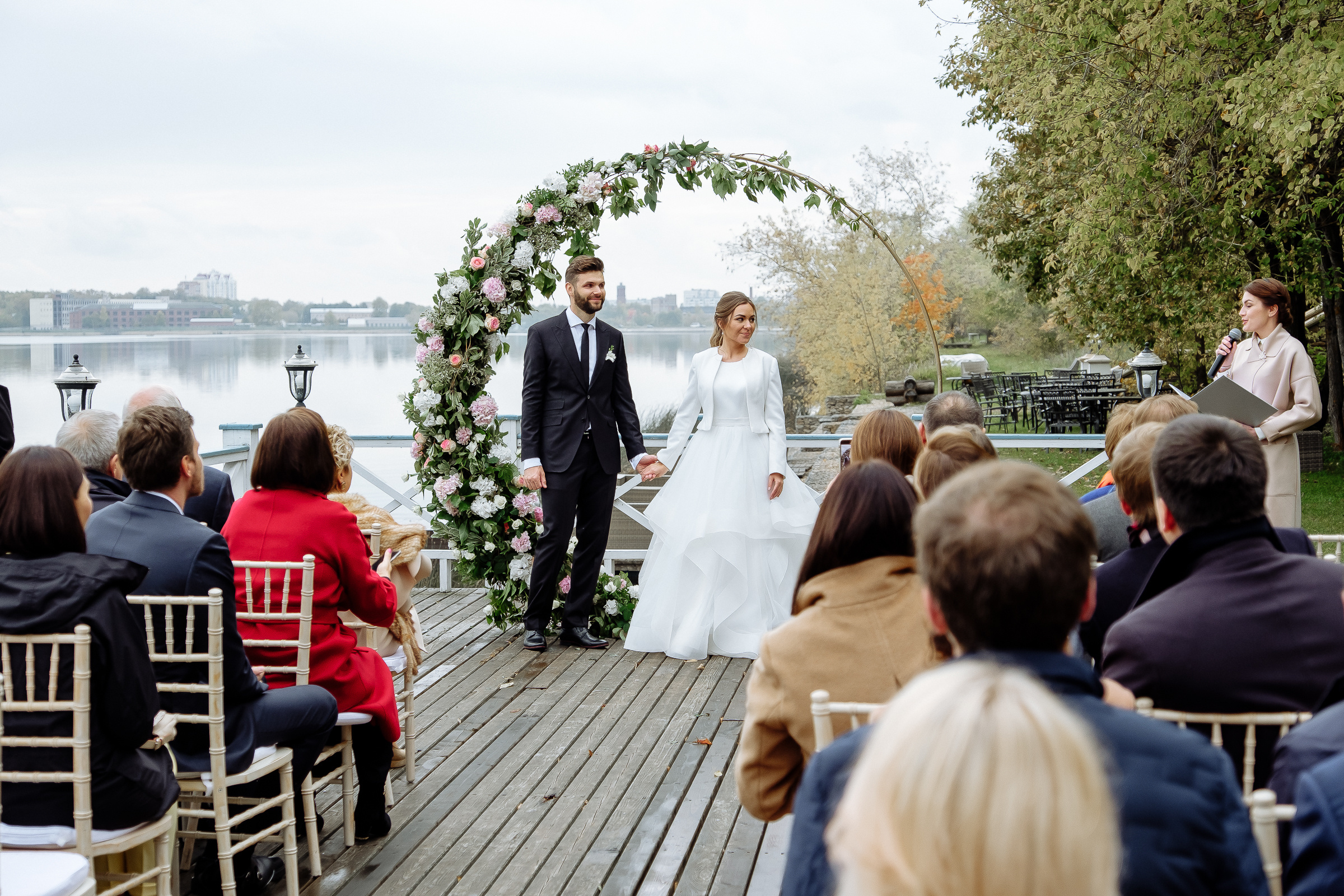 Couple holding hands by river, by Tanya Bodgan, Bude wedding photography.