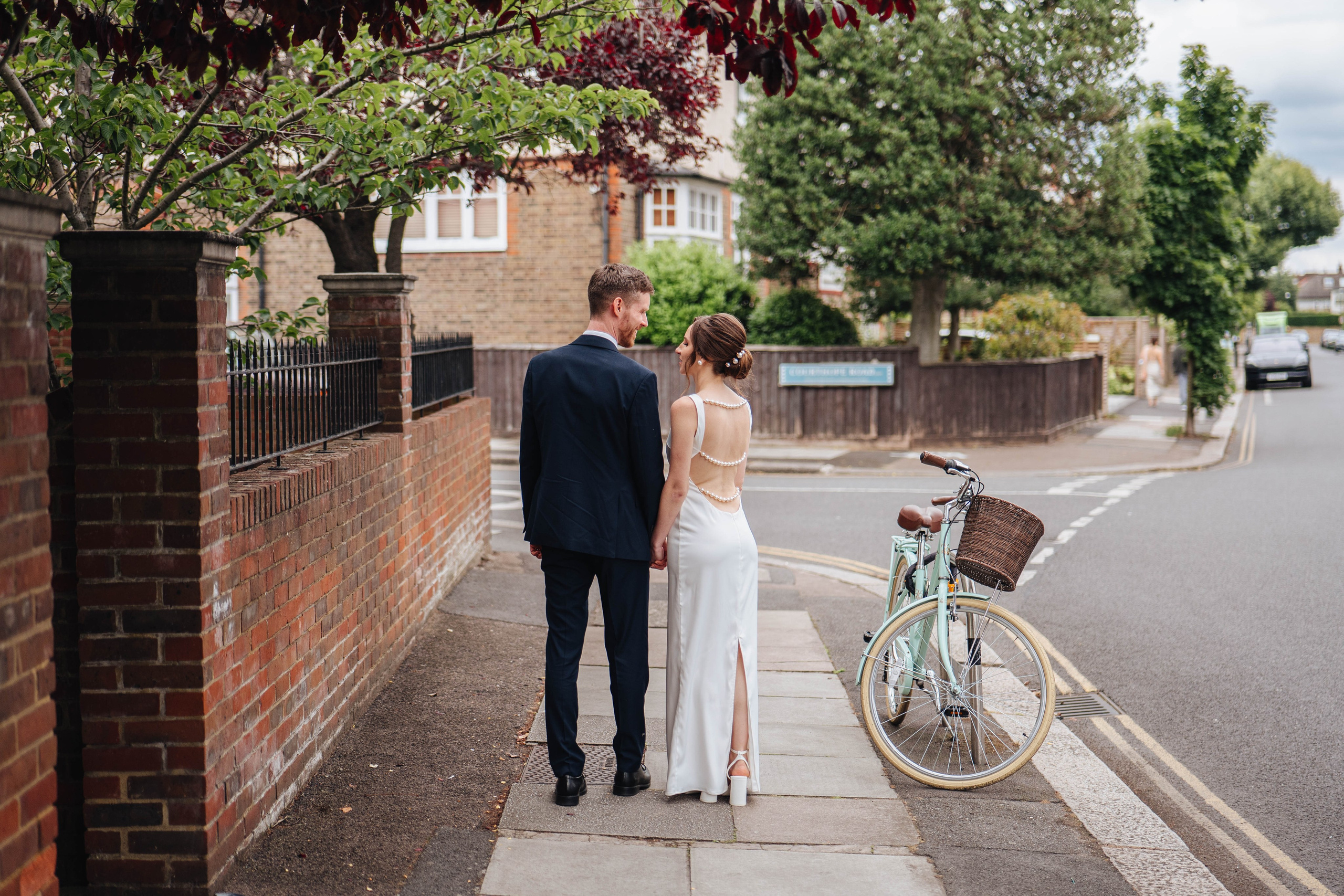 bride and groom from the back walking down the street in London