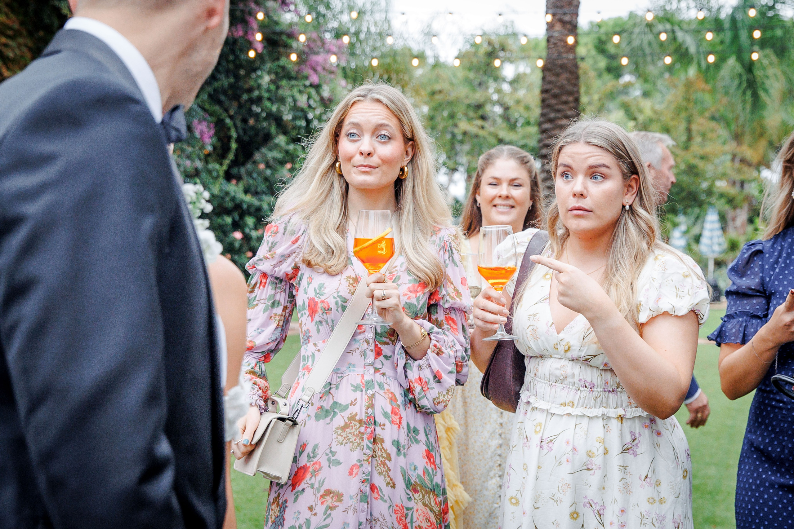 Wedding guests enjoying cocktail hour at a beautiful Barcelona venue, mingling and savoring delicious drinks.