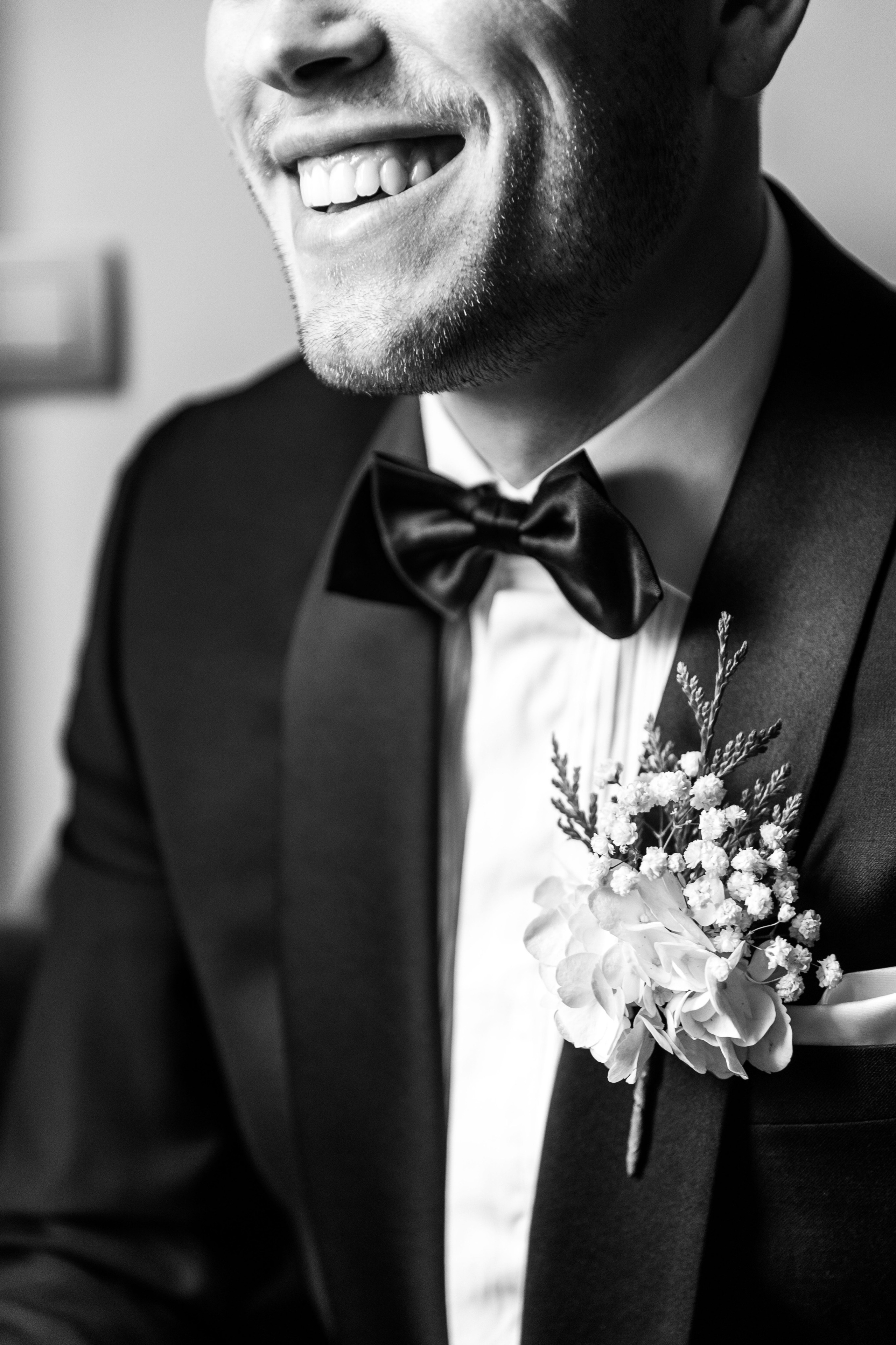 Elegant groom portrait captured in a Spanish wedding venue, showcasing elegant attire.