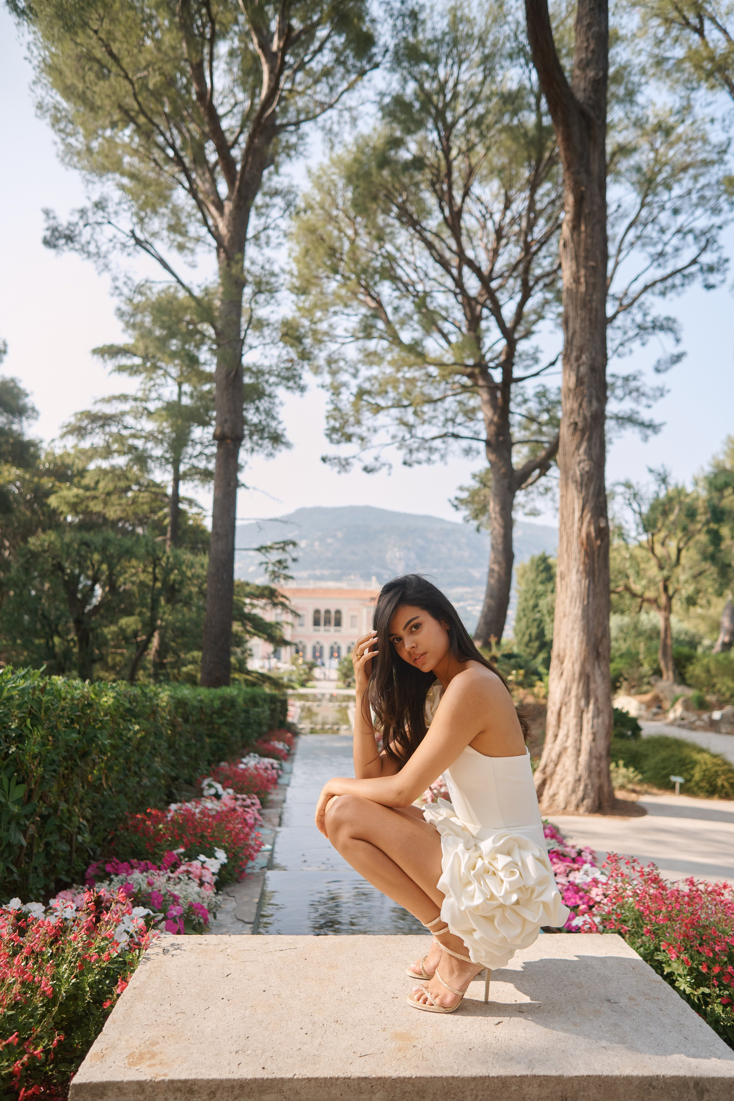 Glamorous photo of woman standing near ornate staircase in luxury villa