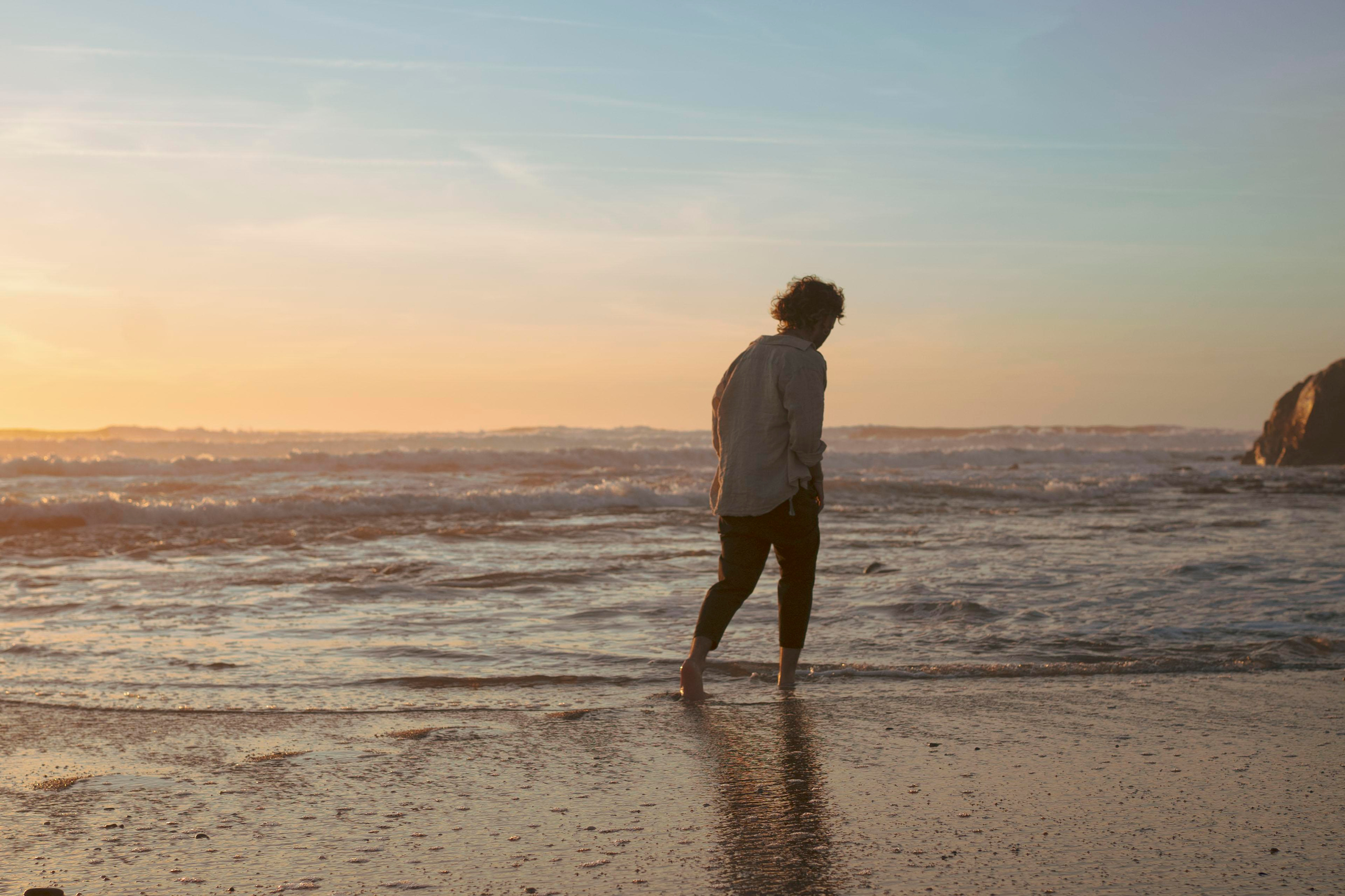 Silhouette of a person with a sunset sky in the background.