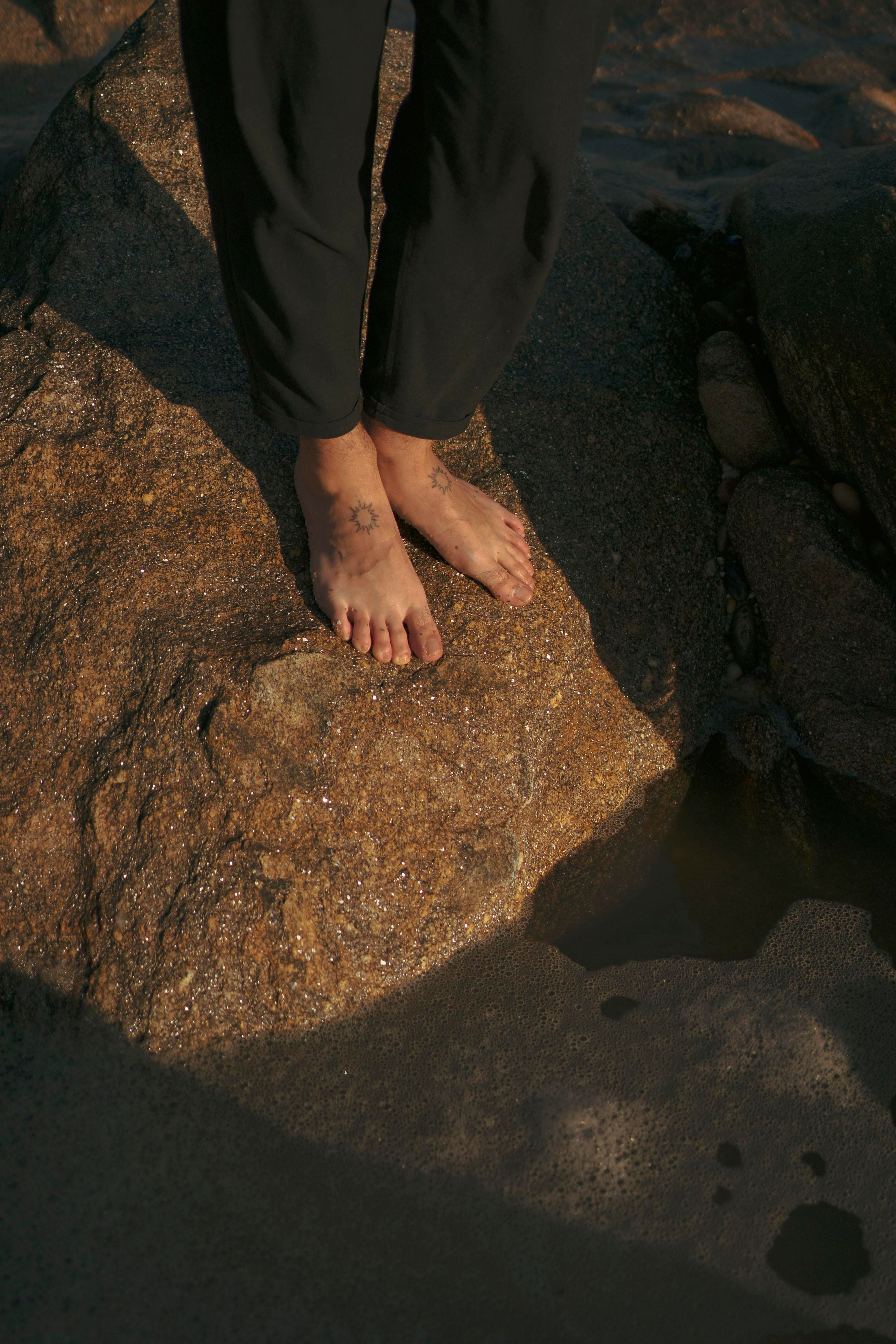 Feet in sunset light on a beach.