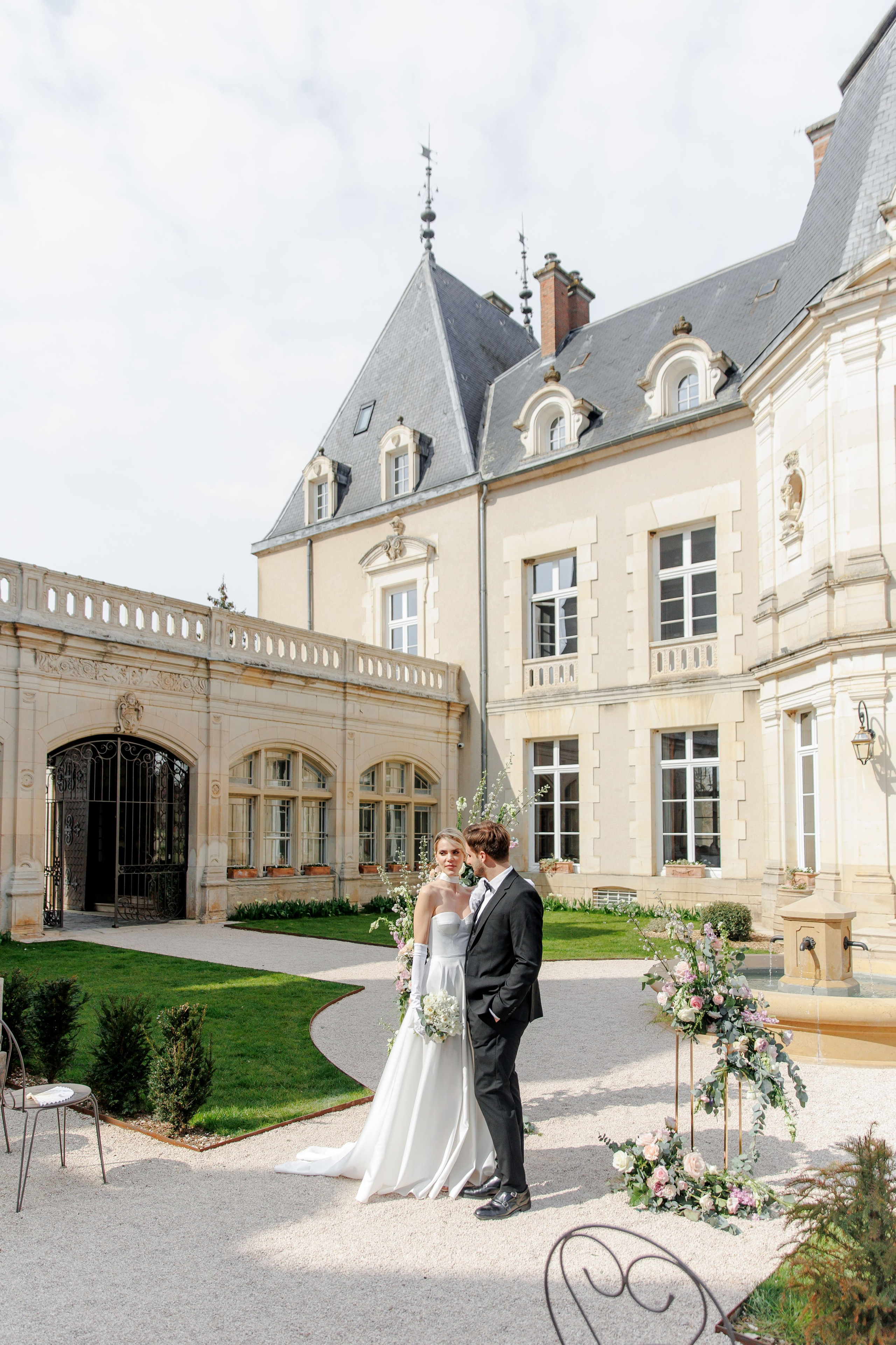 Ceremony setup at a historic wedding chateau in France, showcasing charming architecture and floral arrangements