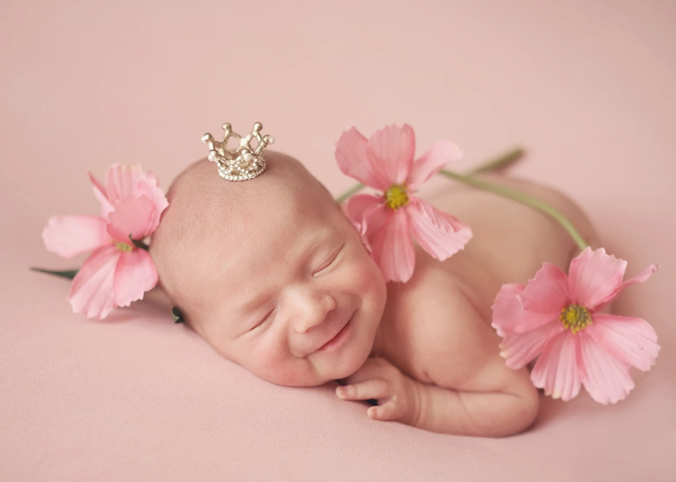 Pink-themed newborn photography with delicate floral details