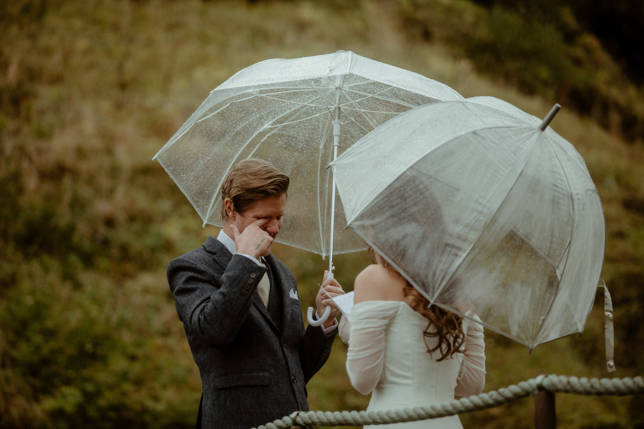 A couple with white umbrellas on their elopement day
