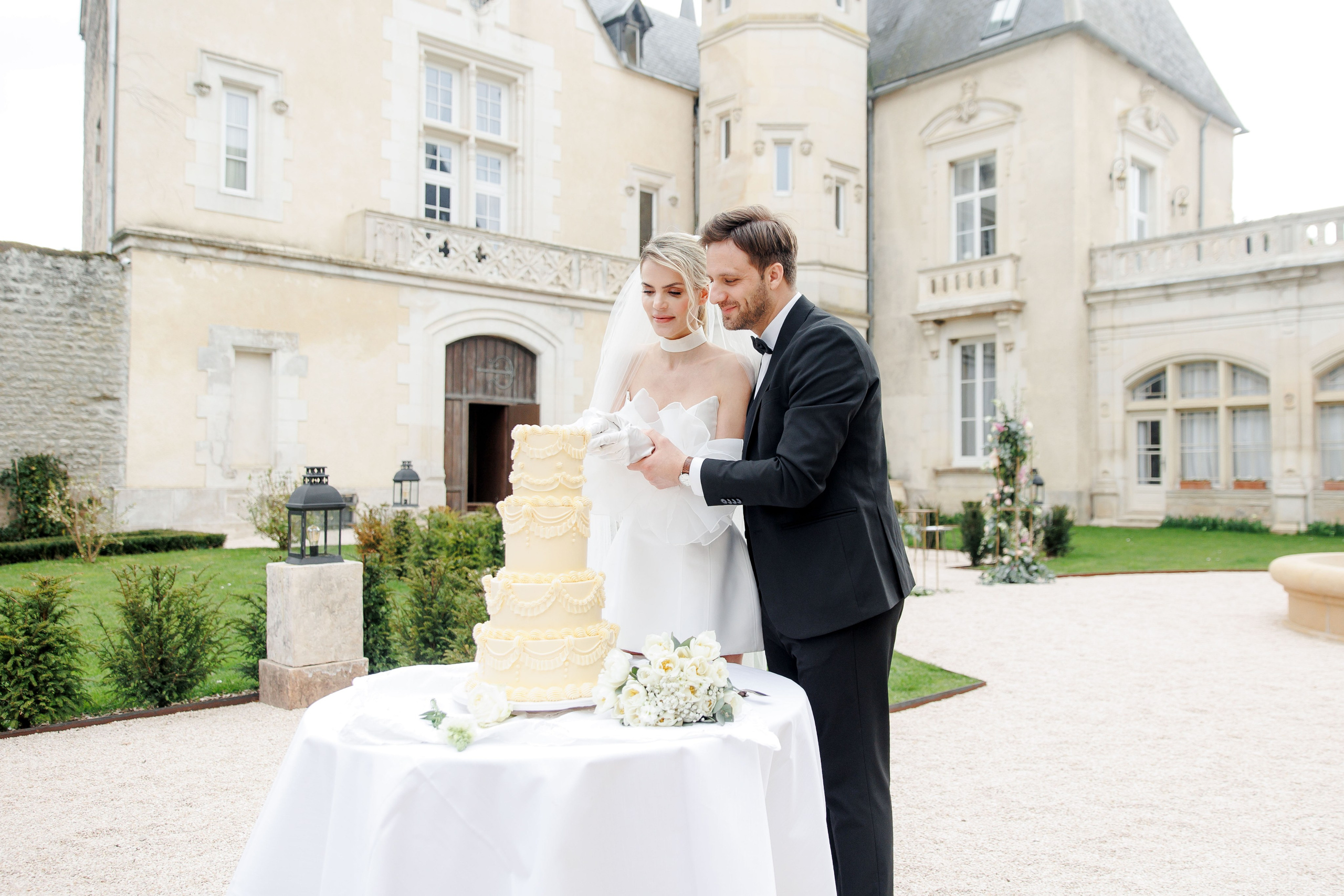 Outdoor wedding ceremony in France with a beautiful view of the chateau. 