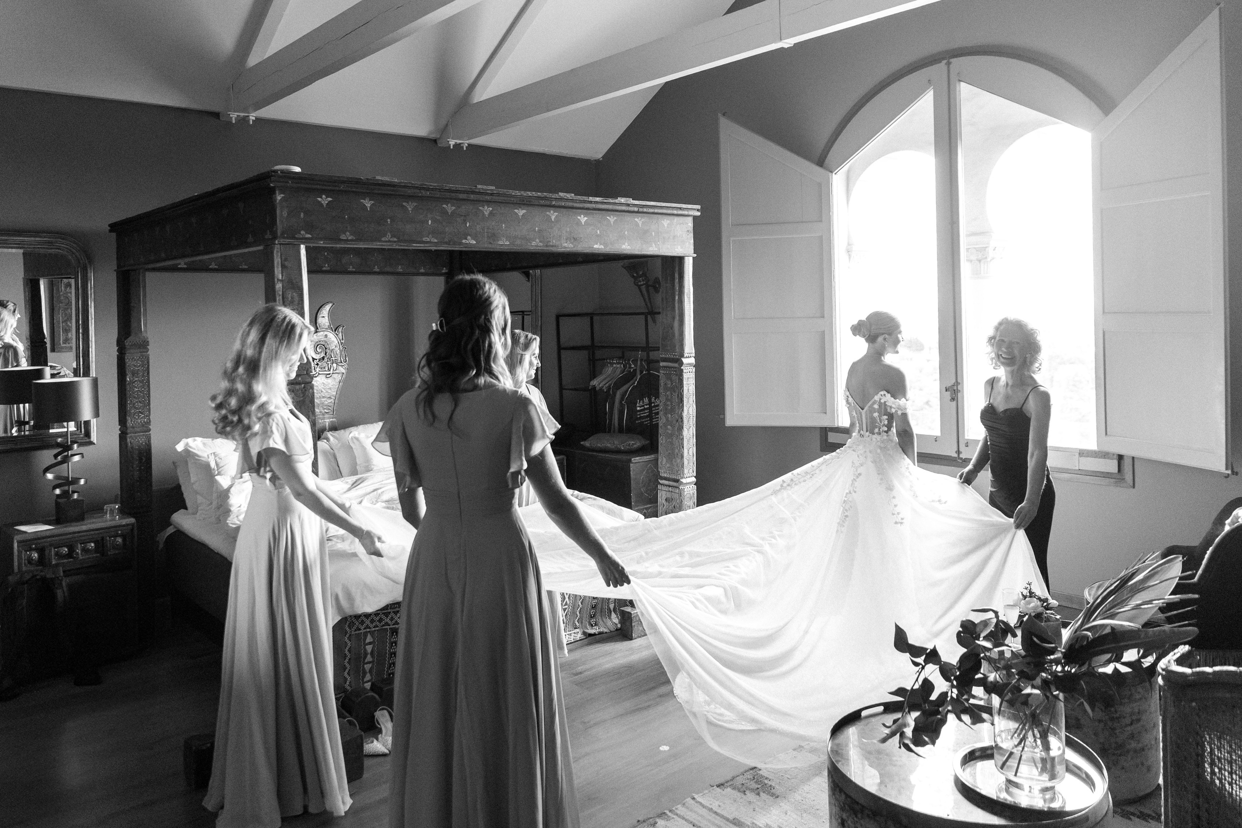 Bride getting ready with her bridesmaids in a stylish Barcelona venue, capturing pre-wedding excitement.