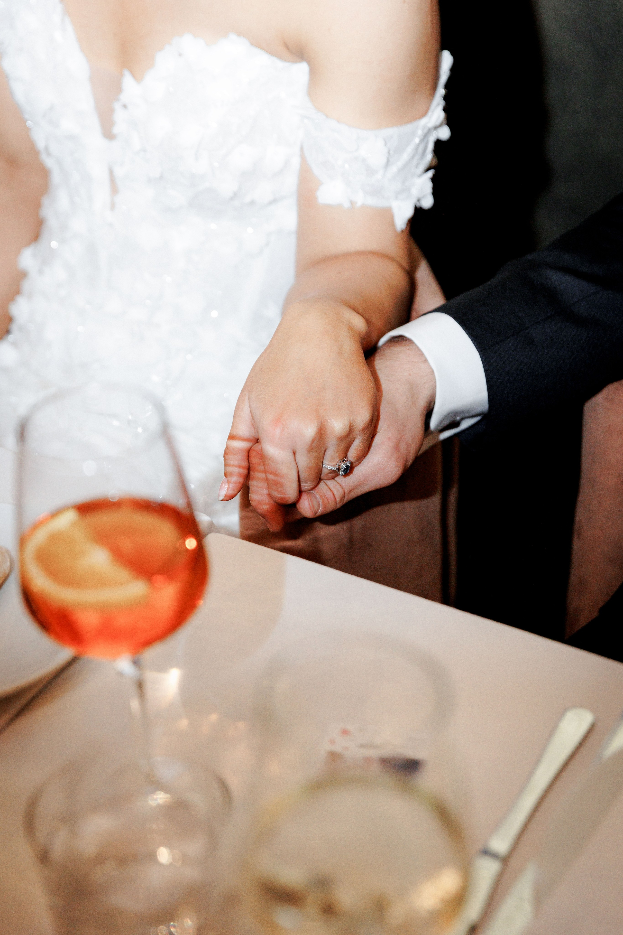 The groom holds the hand of the bride and shares the emotional moment of getting married in Spain. 