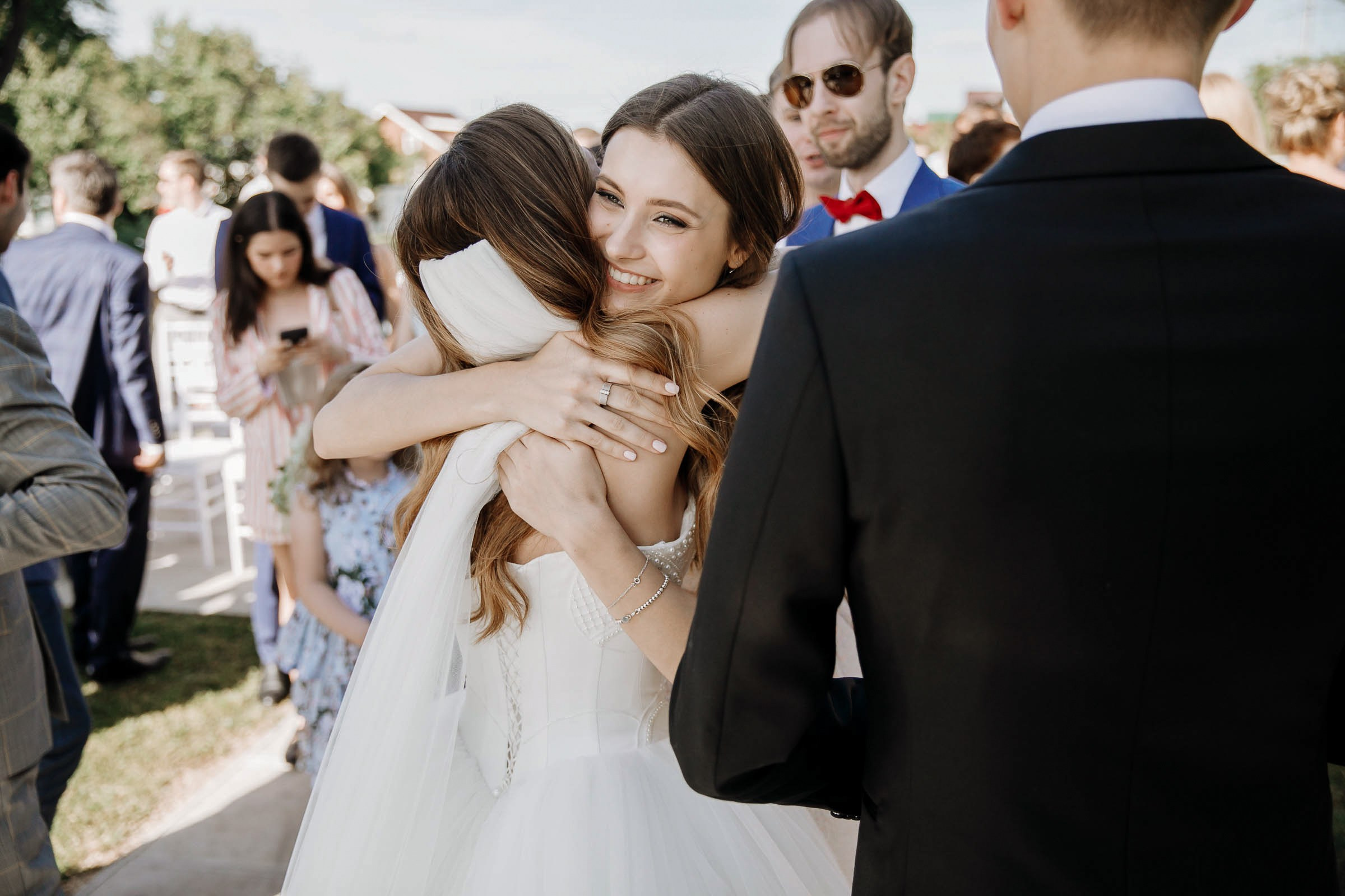 Guests at ceremony congratulating bride, by Tanya Bodgan, Bude, Cornwall wedding photography.