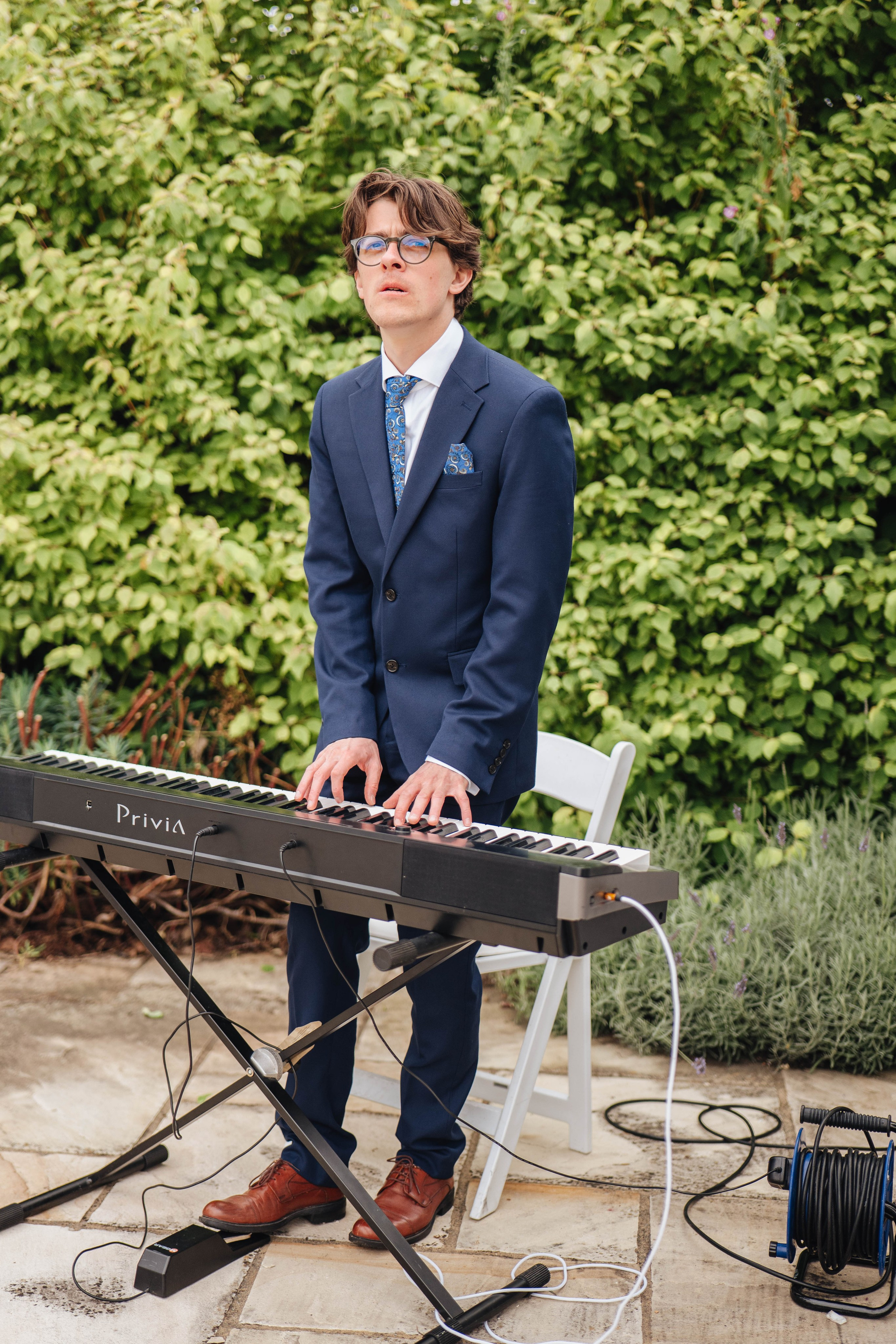 a friend of a family playing piano at the wedding ceremony