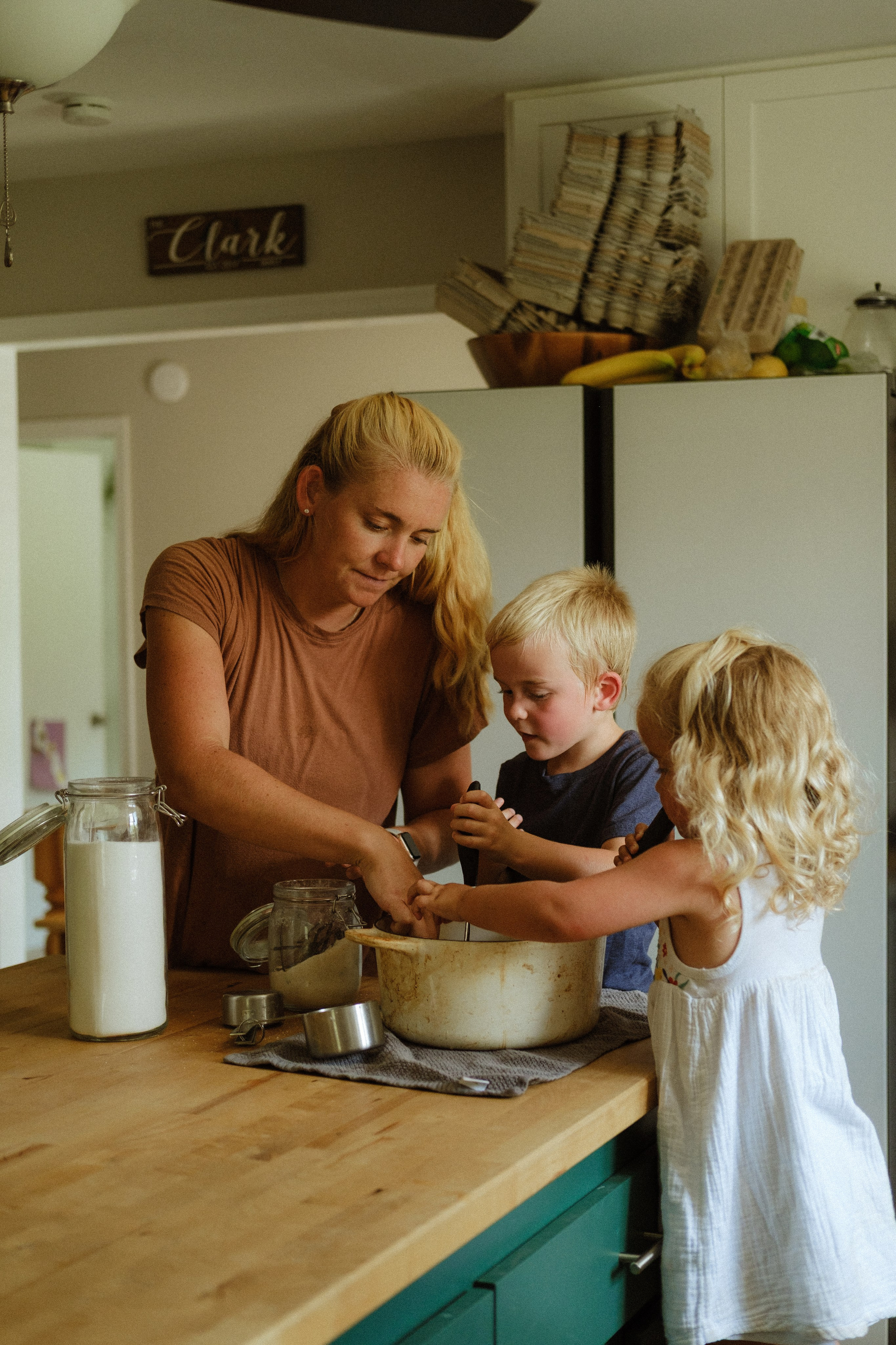 Mother and two of her children together in the kitchen making preserves in Richmond, VA
